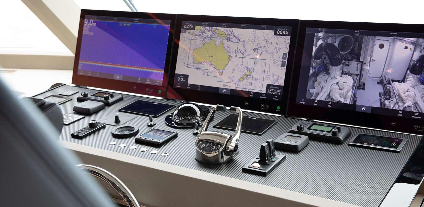 a desk with a computer and several monitors aboard OCEAN ALEXANDER 27R03 Yacht for Charter