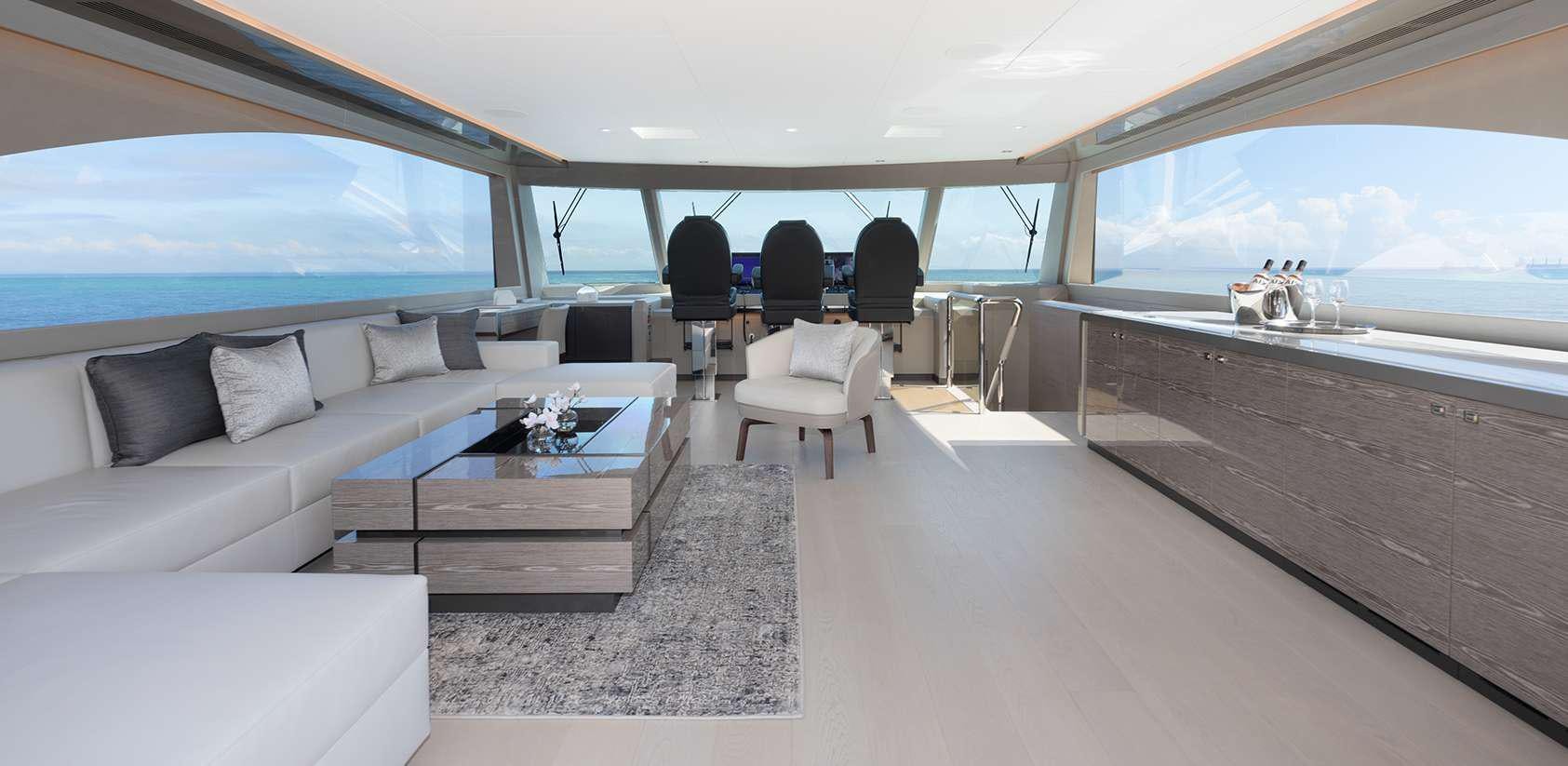 a room with a couch and a table and chairs aboard OCEAN ALEXANDER 27R03 Yacht for Charter