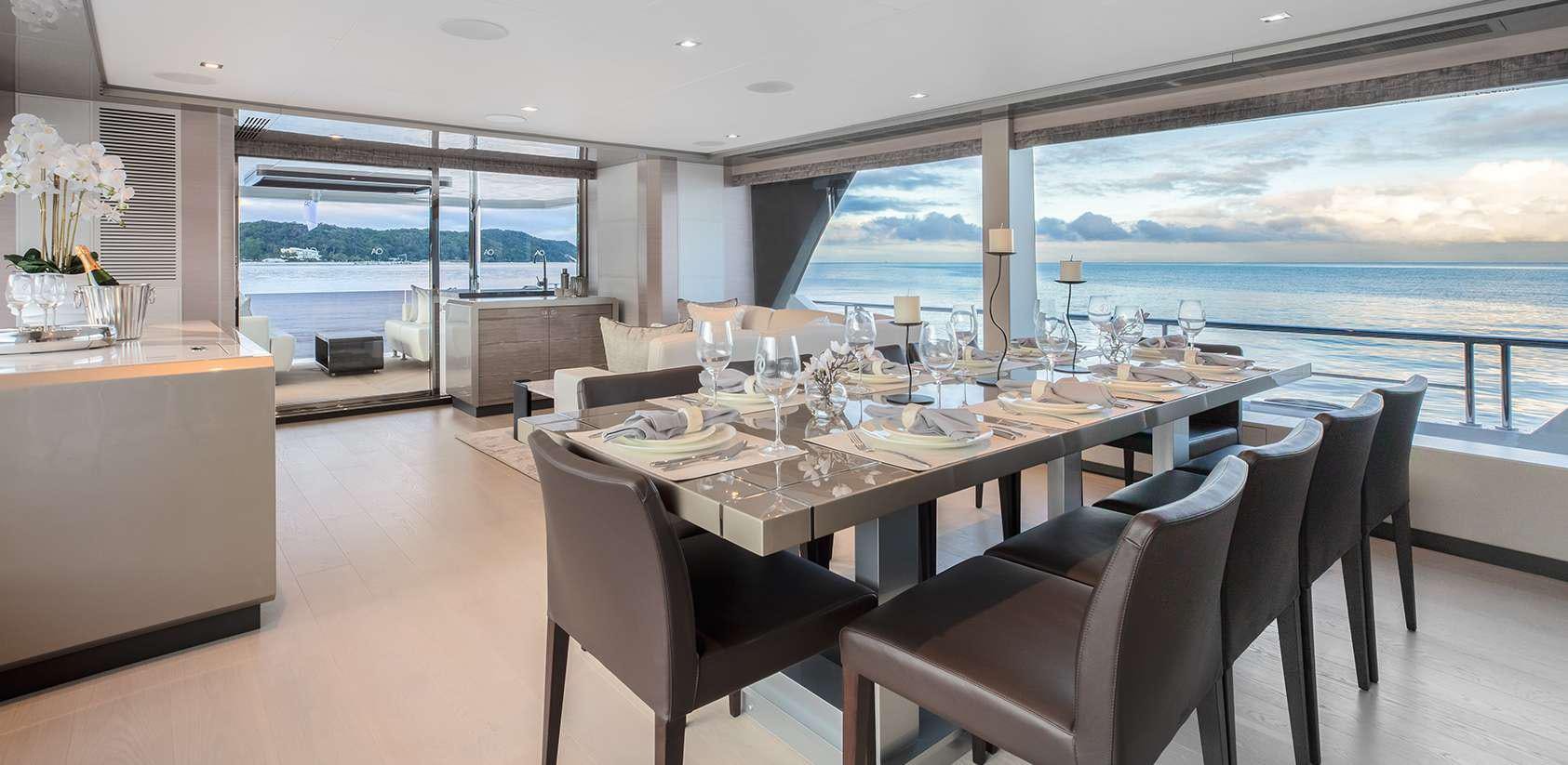 a large dining room with a large window overlooking the ocean aboard OCEAN ALEXANDER 27R03 Yacht for Charter