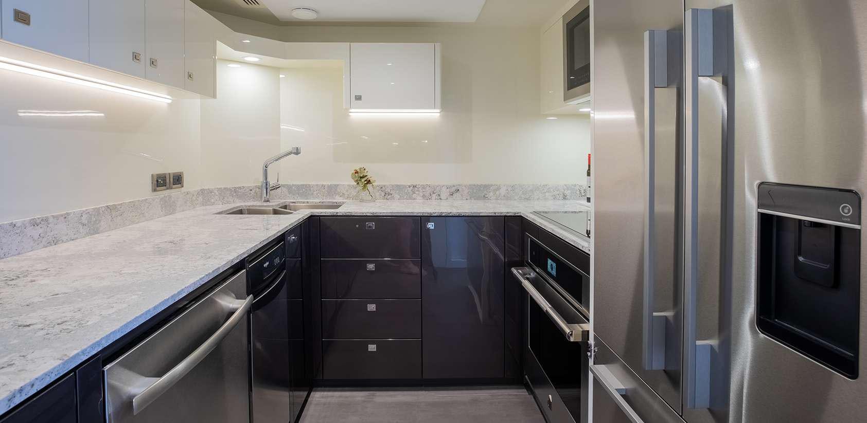 a kitchen with stainless steel appliances aboard OCEAN ALEXANDER 27R03 Yacht for Charter