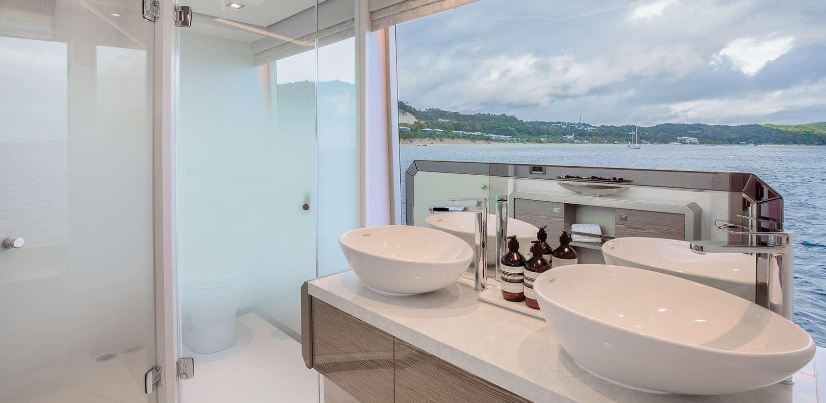a bathroom with a sink and a tub aboard OCEAN ALEXANDER 27R03 Yacht for Charter