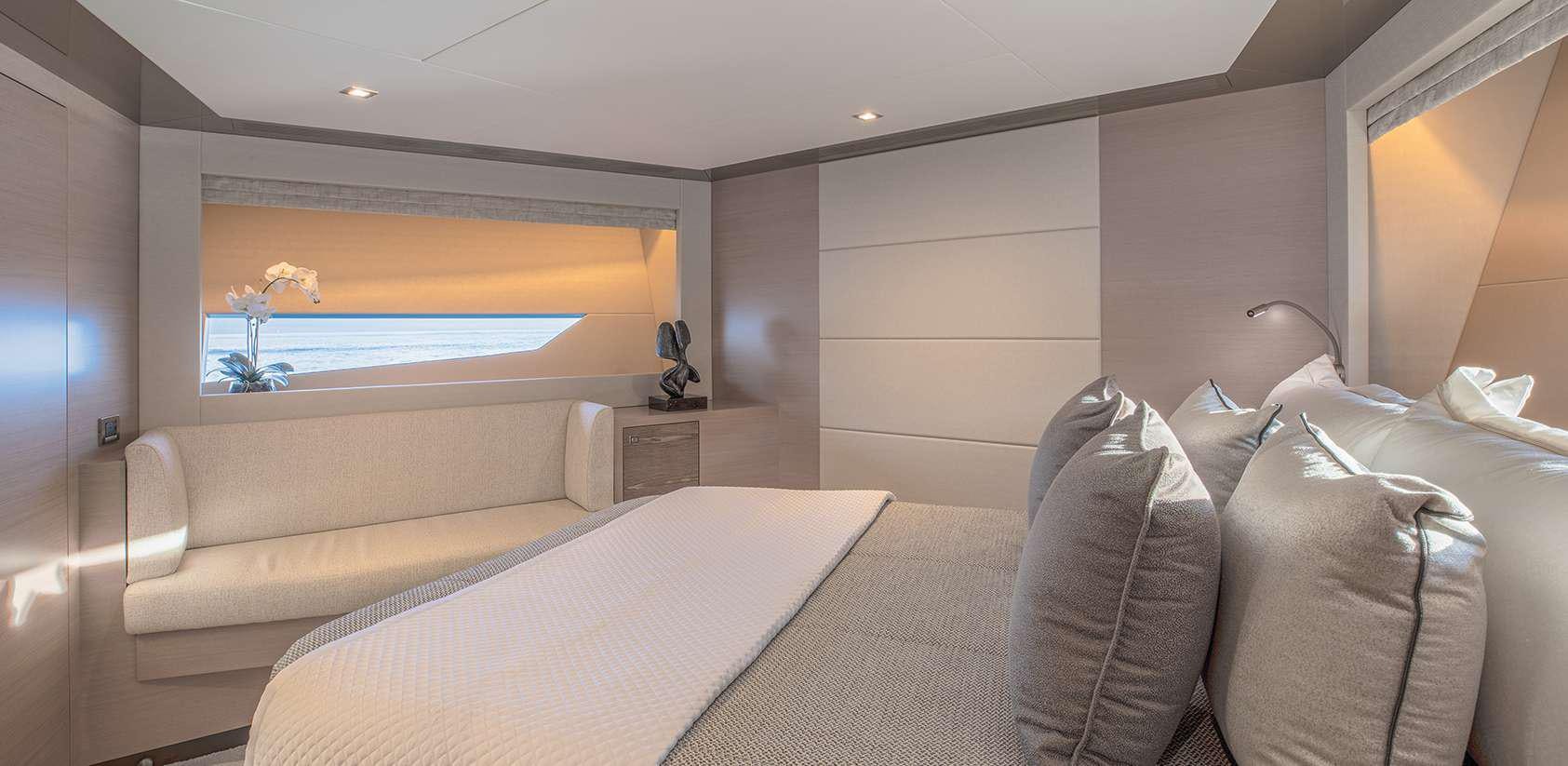 a room with a couch and a television aboard OCEAN ALEXANDER 27R03 Yacht for Charter