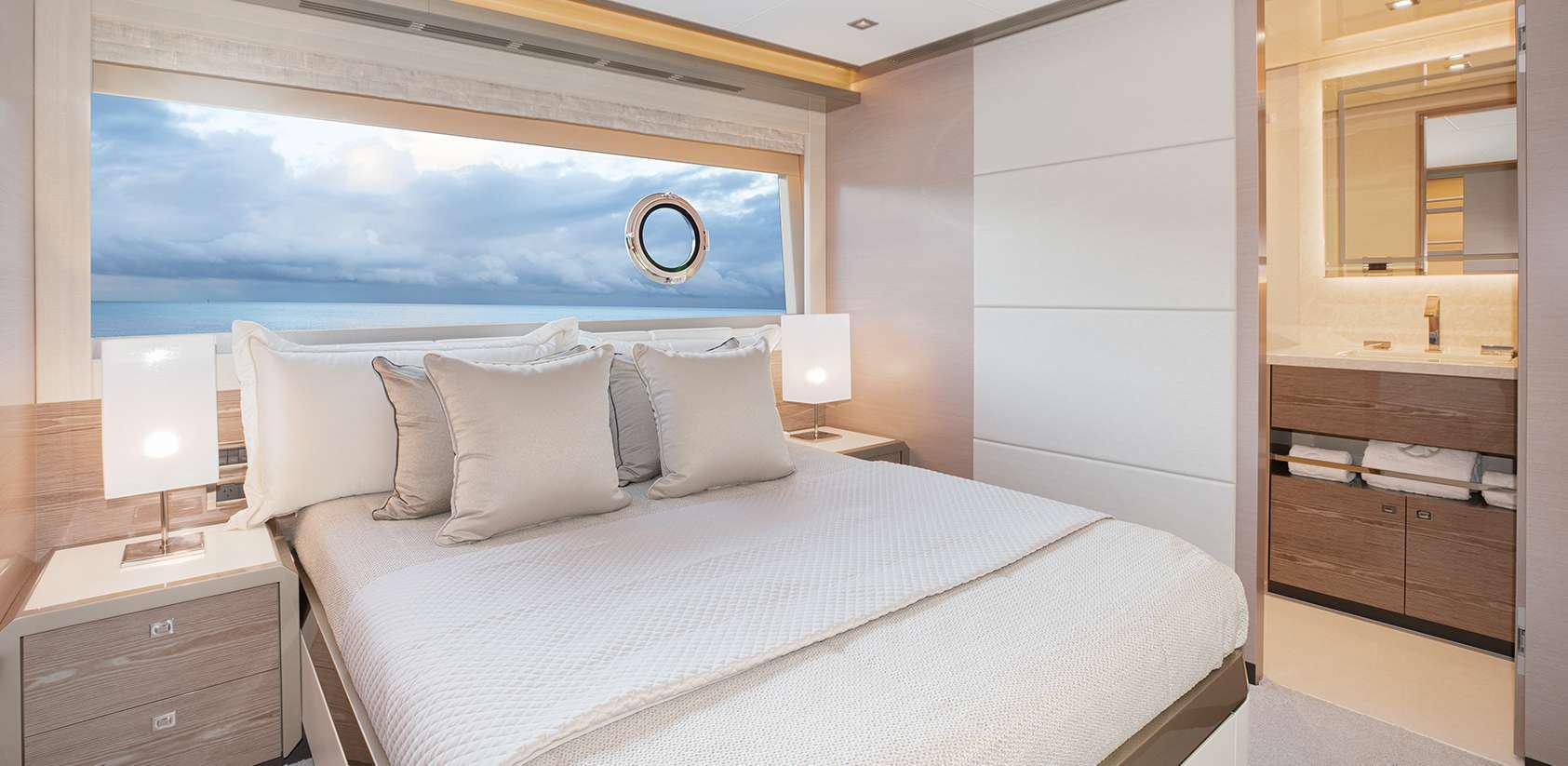 a bed with white sheets aboard OCEAN ALEXANDER 27R03 Yacht for Charter