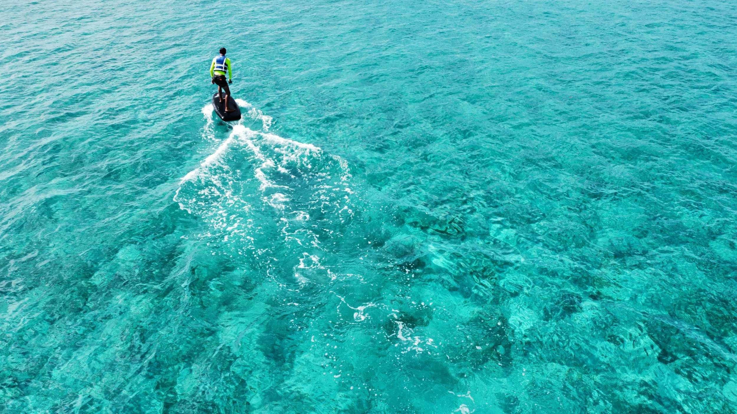 a man riding a wave aboard PRINCESS MILA Yacht for Charter