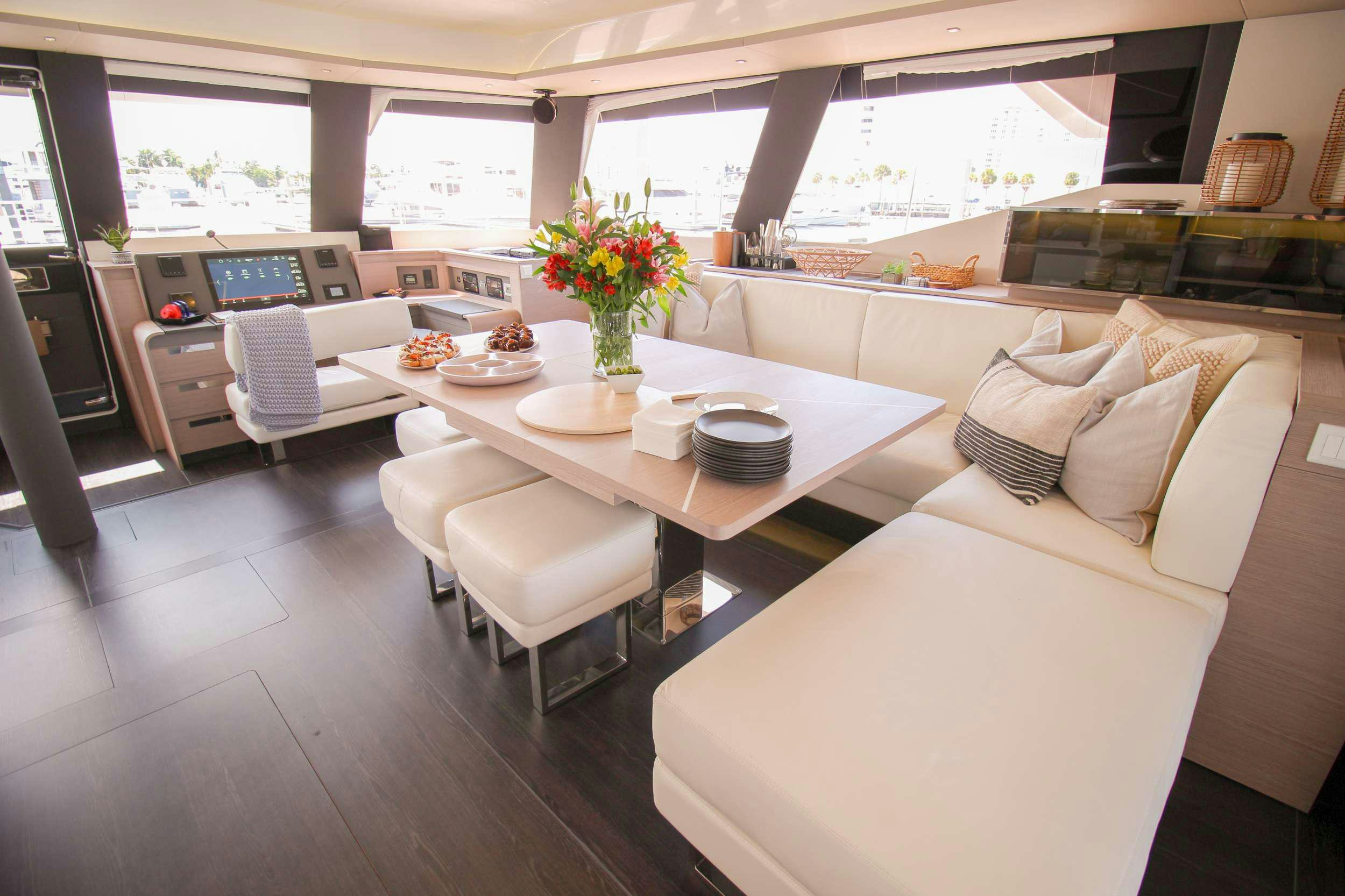 a room with a table chairs and a couch aboard PRINCESS MILA Yacht for Charter