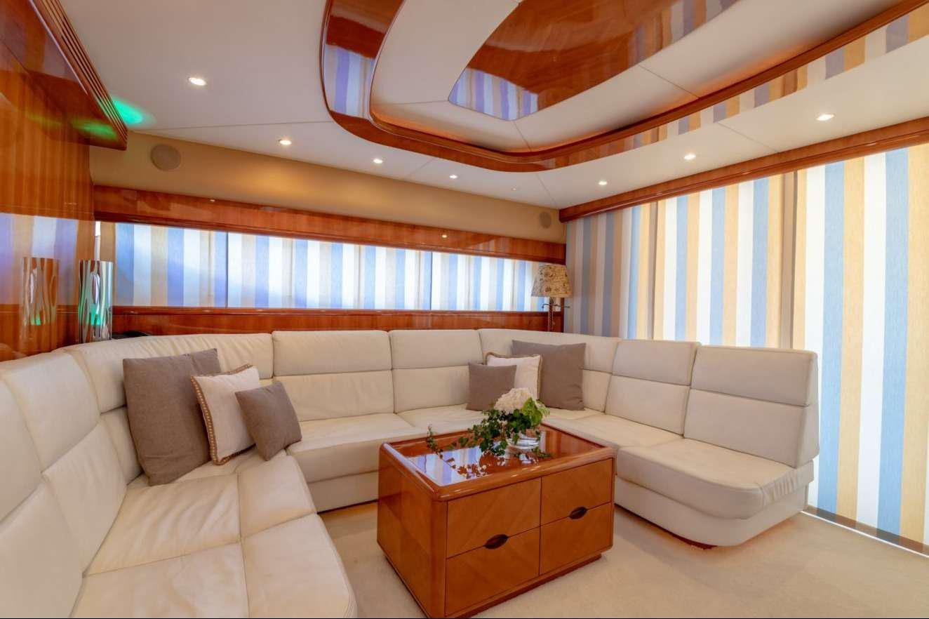 a living room with a couch and a table aboard VENUS SECRETS Yacht for Charter