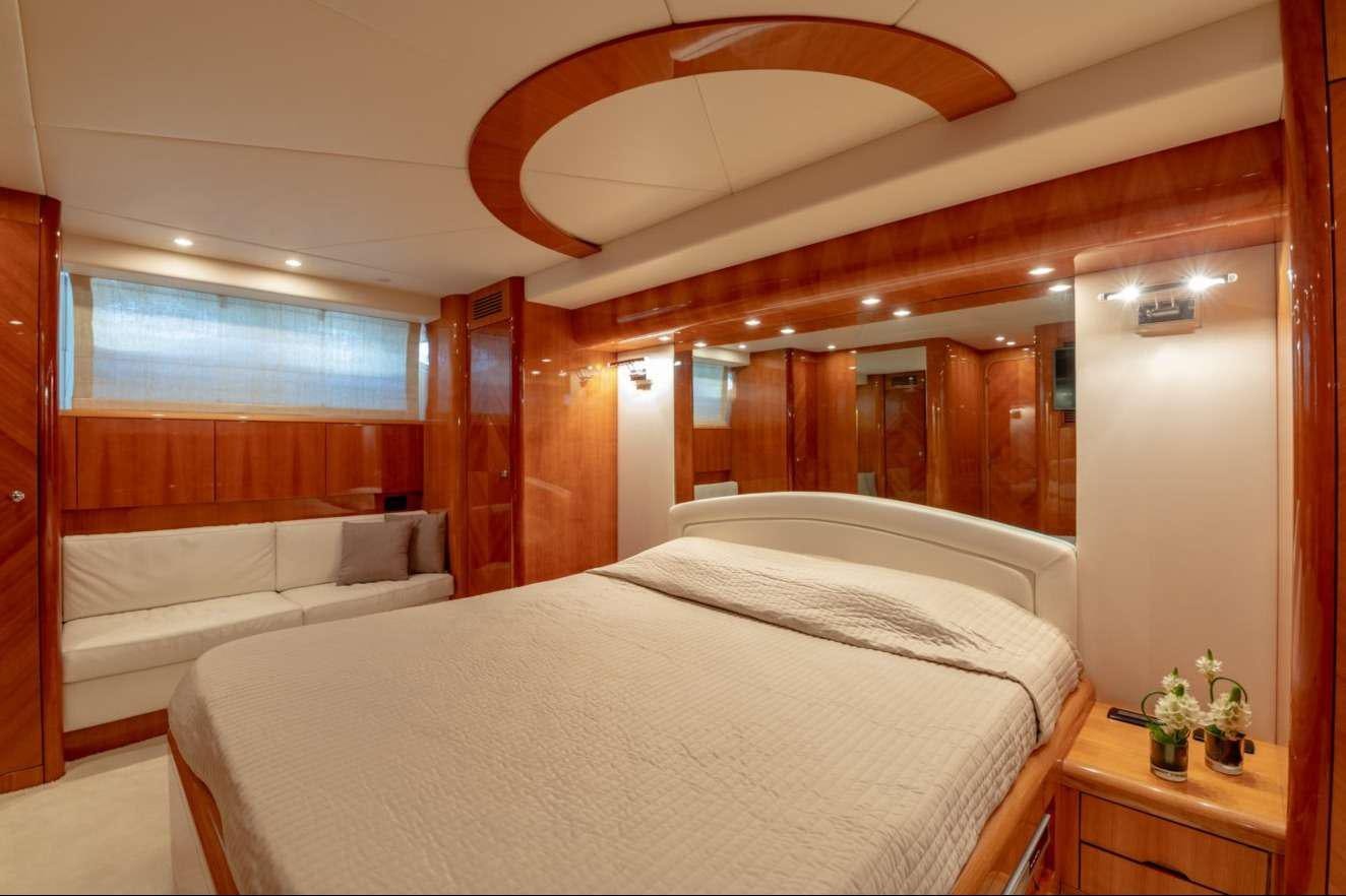 a room with a bed and a table aboard VENUS SECRETS Yacht for Charter