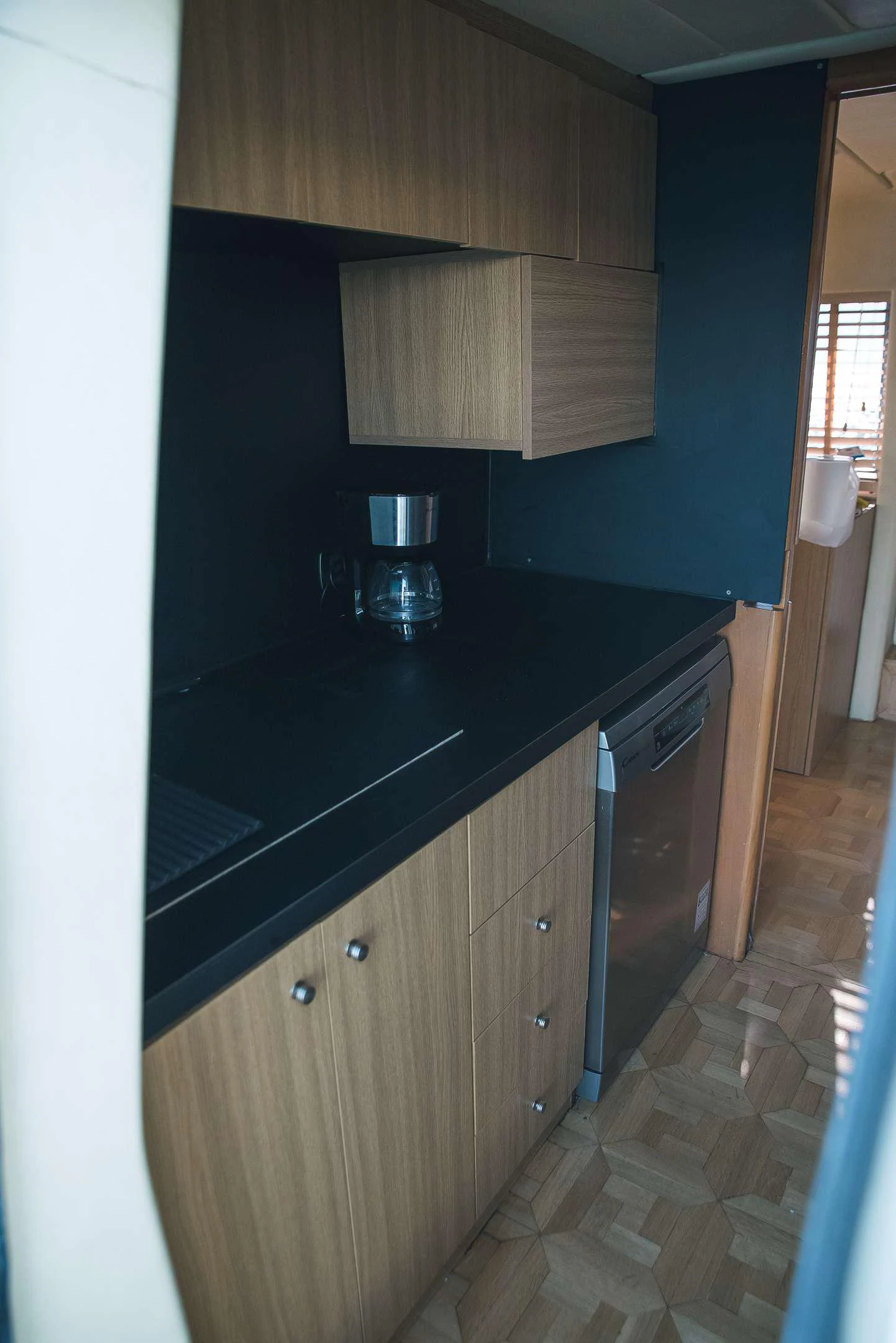 a kitchen with black counter tops aboard TEMPTATION Yacht for Charter