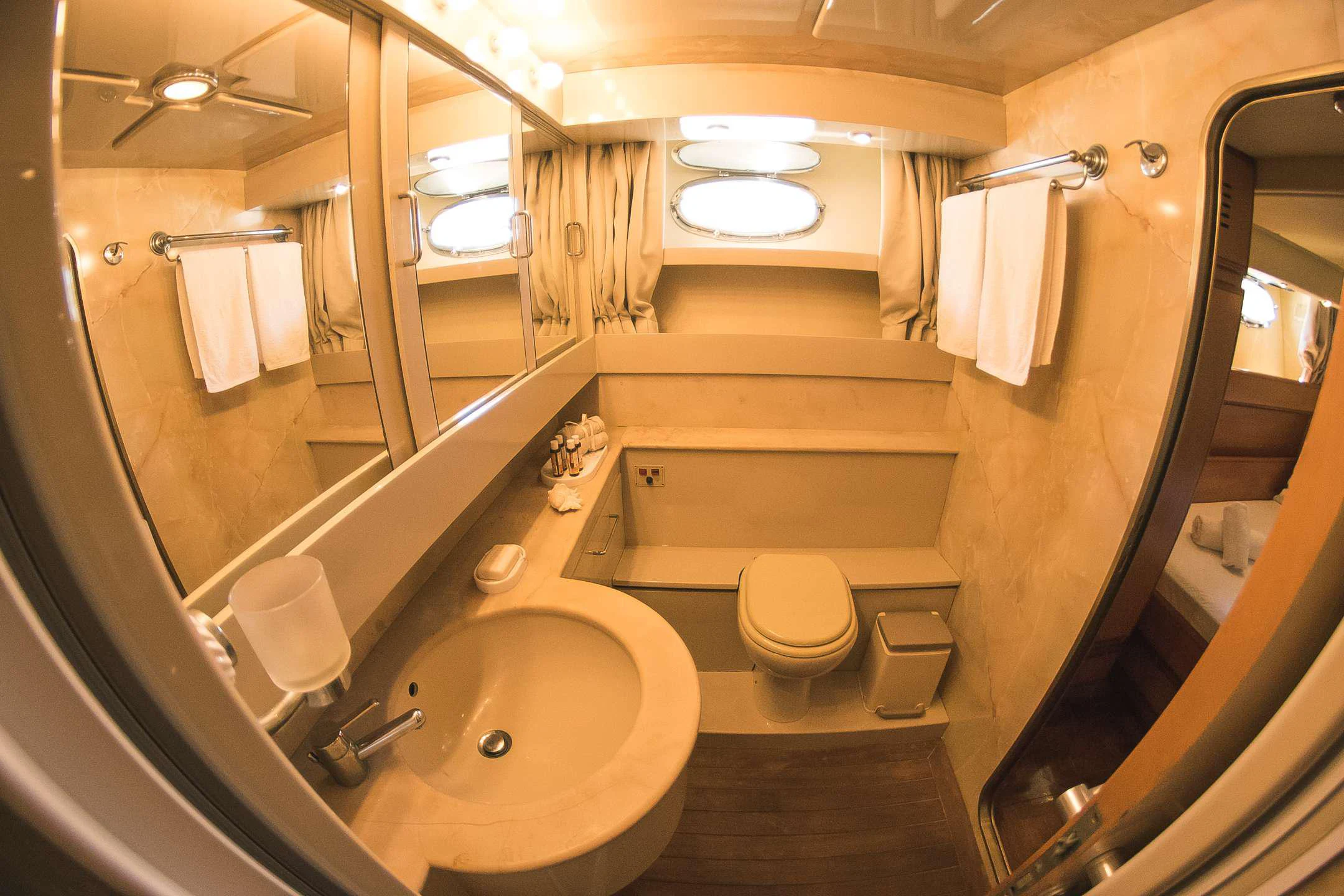 a bathroom with a sink toilet and bathtub aboard TEMPTATION Yacht for Charter