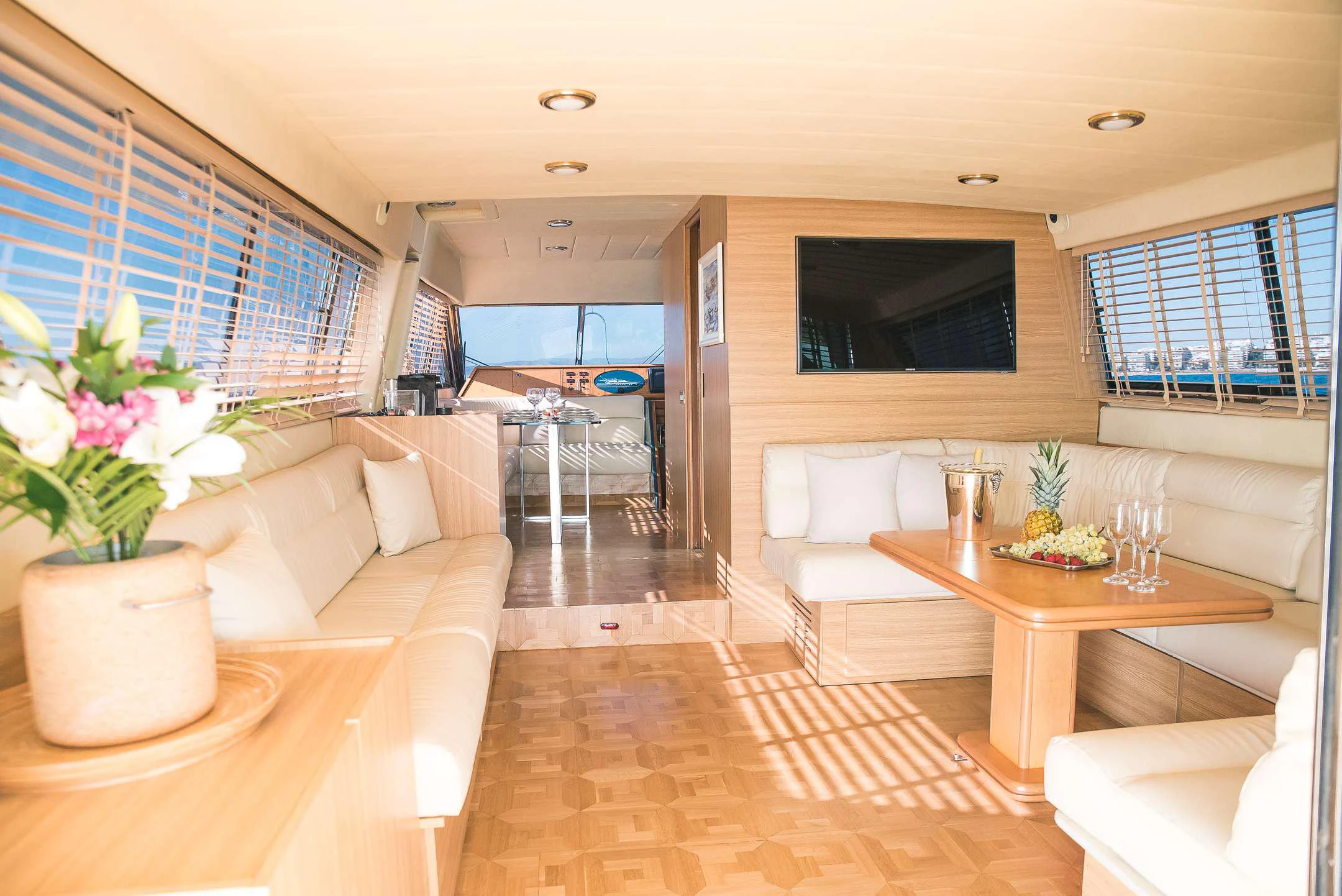 a living room with a table and couches aboard TEMPTATION Yacht for Charter
