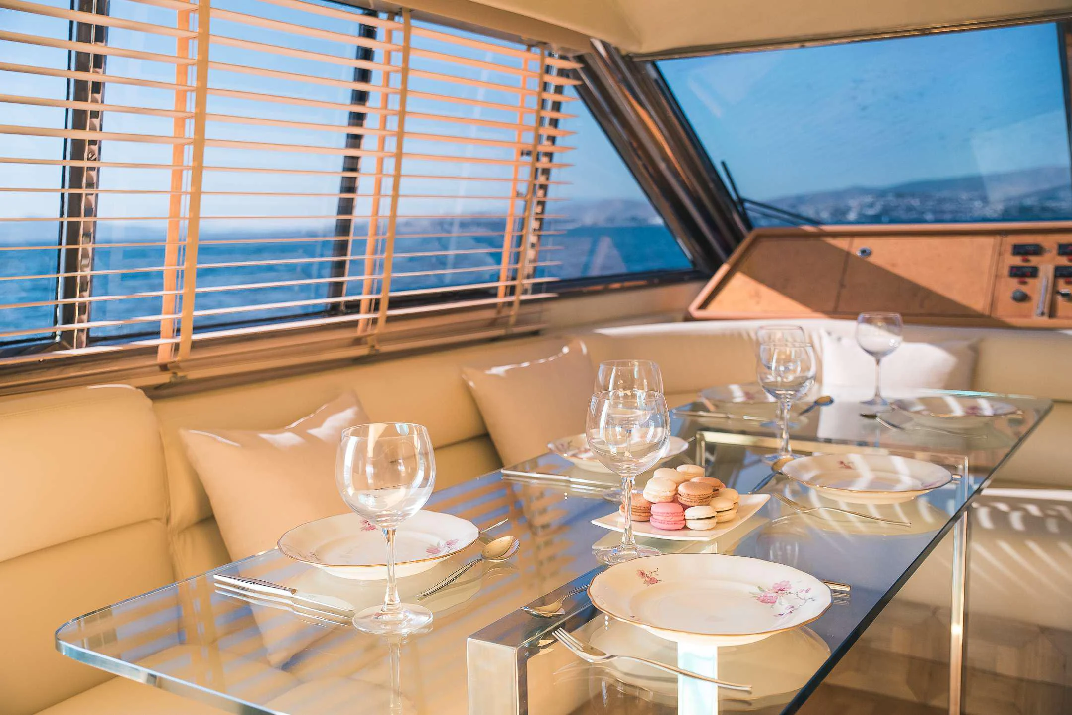 a table with plates and glasses aboard TEMPTATION Yacht for Charter