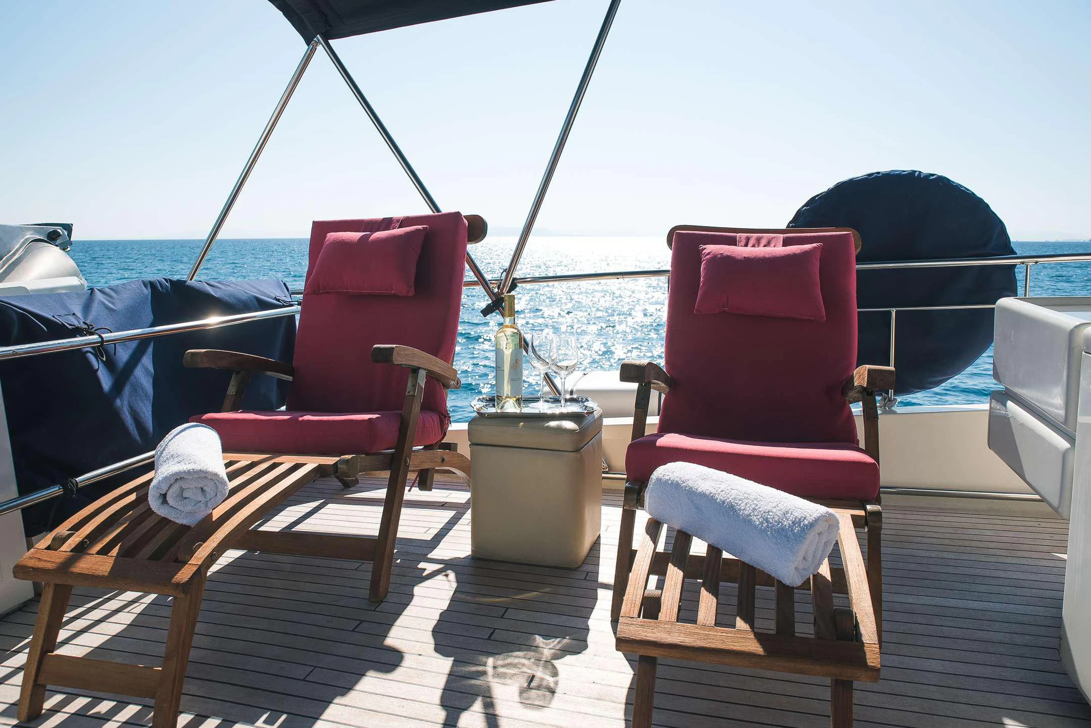 a deck with chairs and a table on it aboard TEMPTATION Yacht for Charter