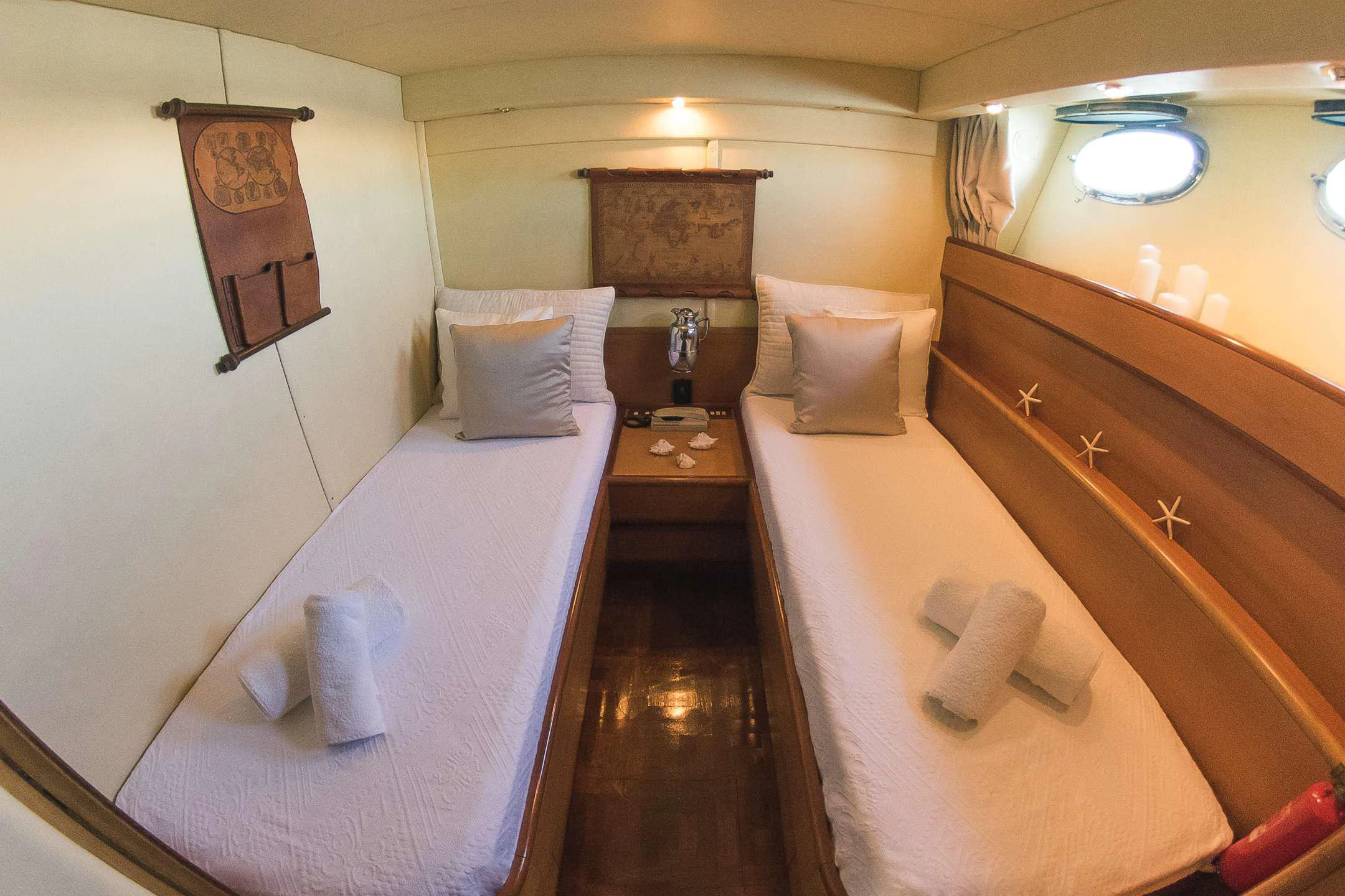 a room with a bed and a dresser aboard TEMPTATION Yacht for Charter