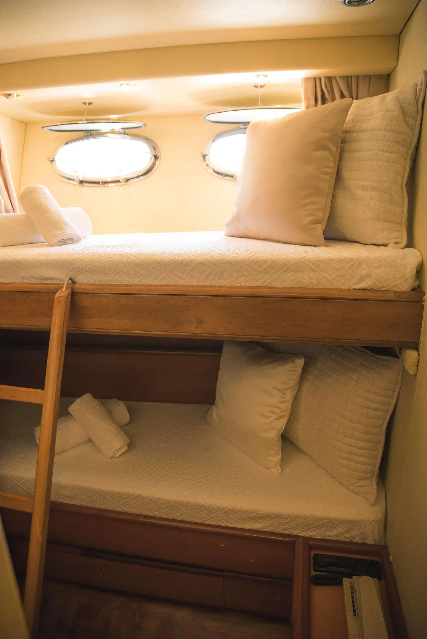 a bed with white sheets aboard TEMPTATION Yacht for Charter
