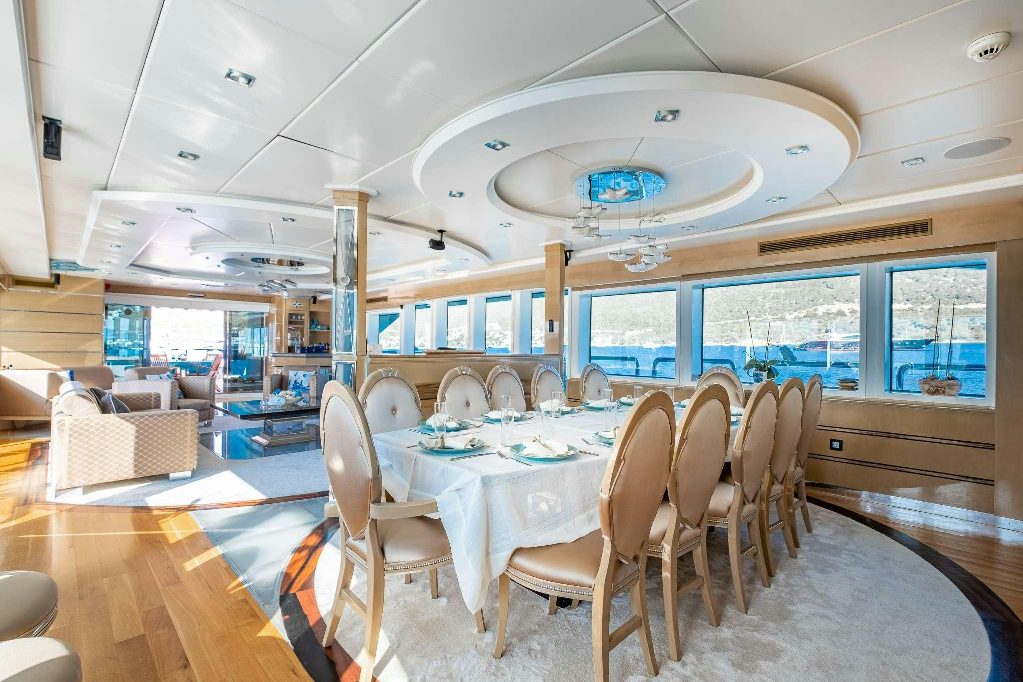 a room with tables and chairs aboard DESTINY Yacht for Charter
