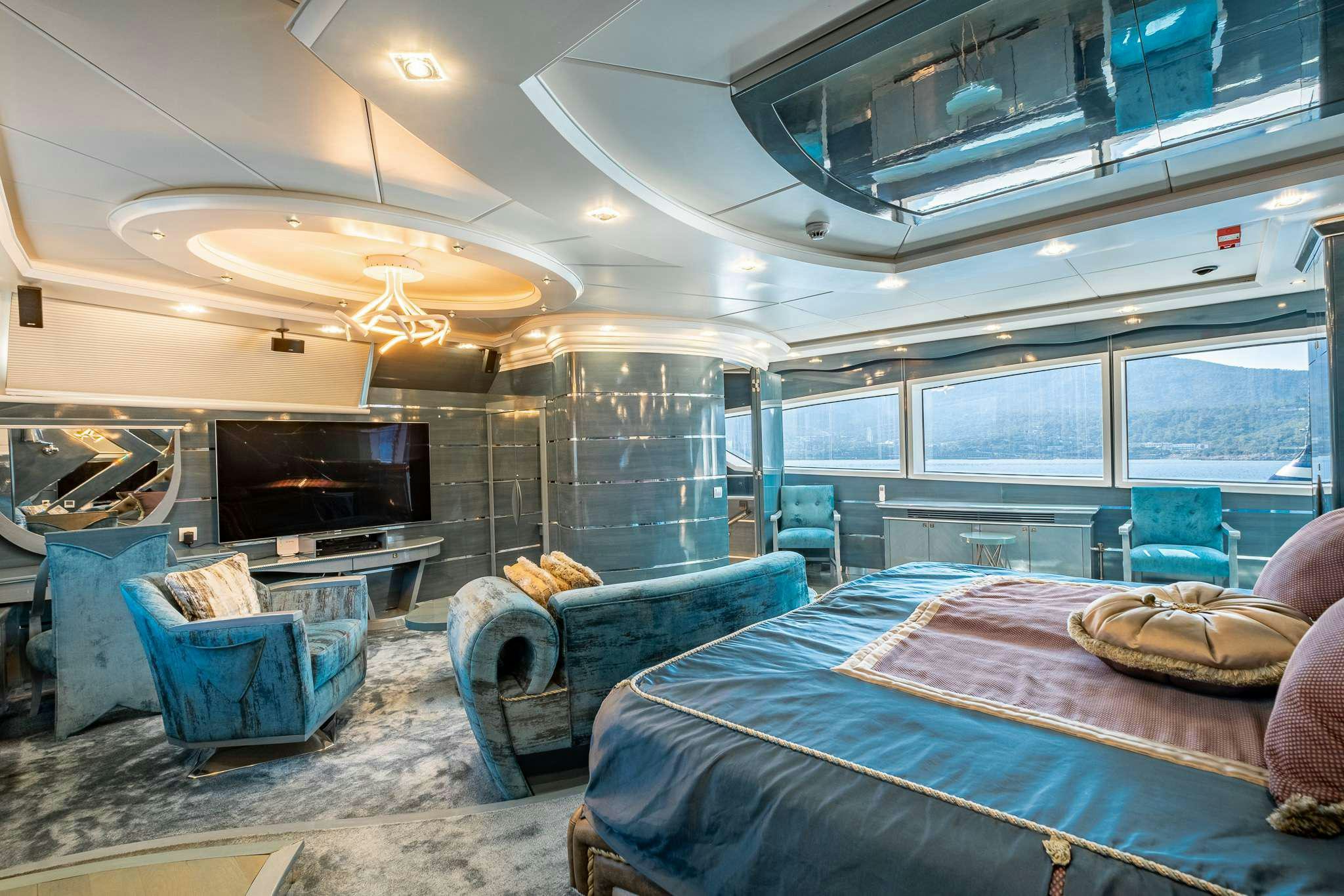 a room with a bed and a couch aboard DESTINY Yacht for Charter