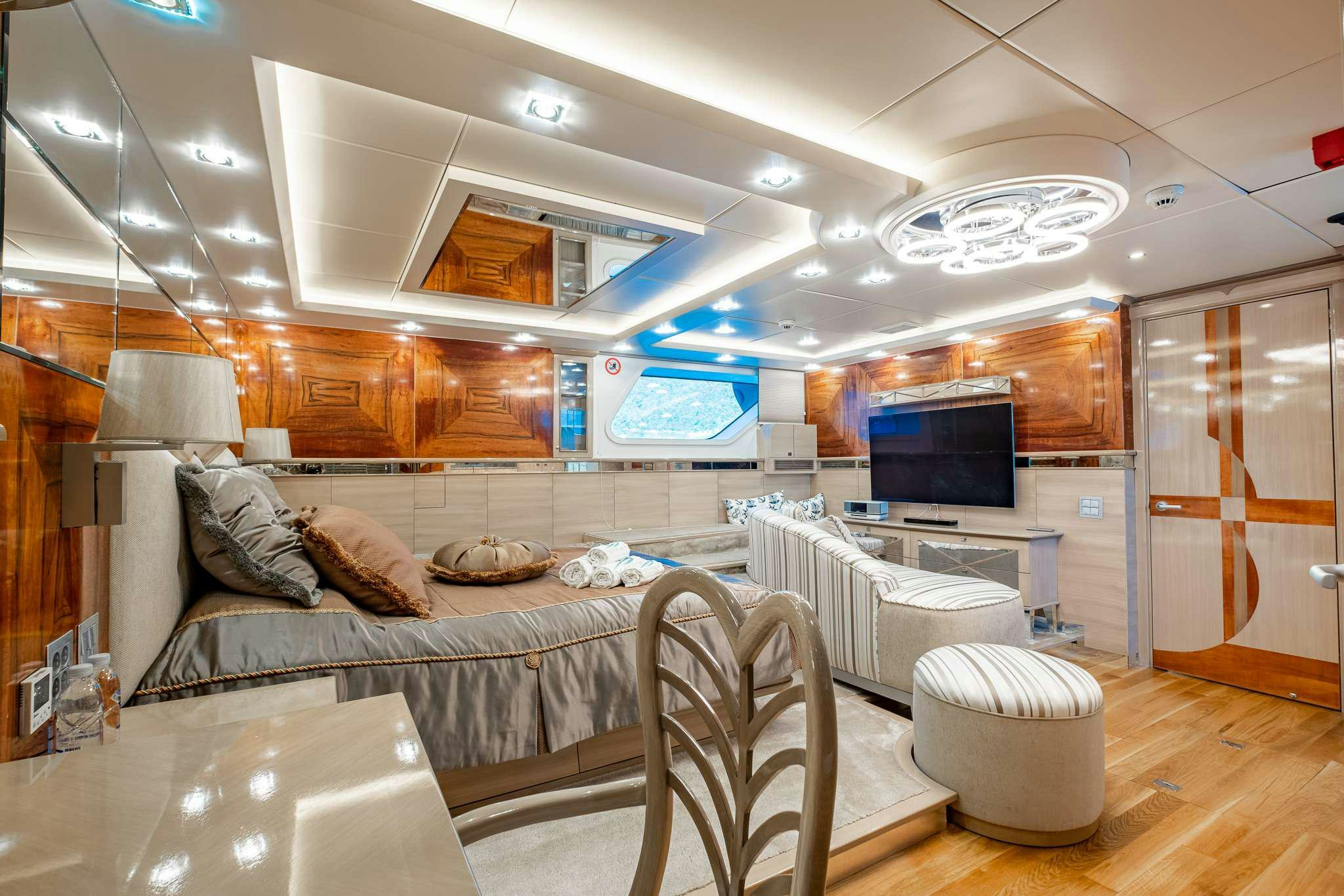 a bedroom with a bed and a tv aboard DESTINY Yacht for Charter