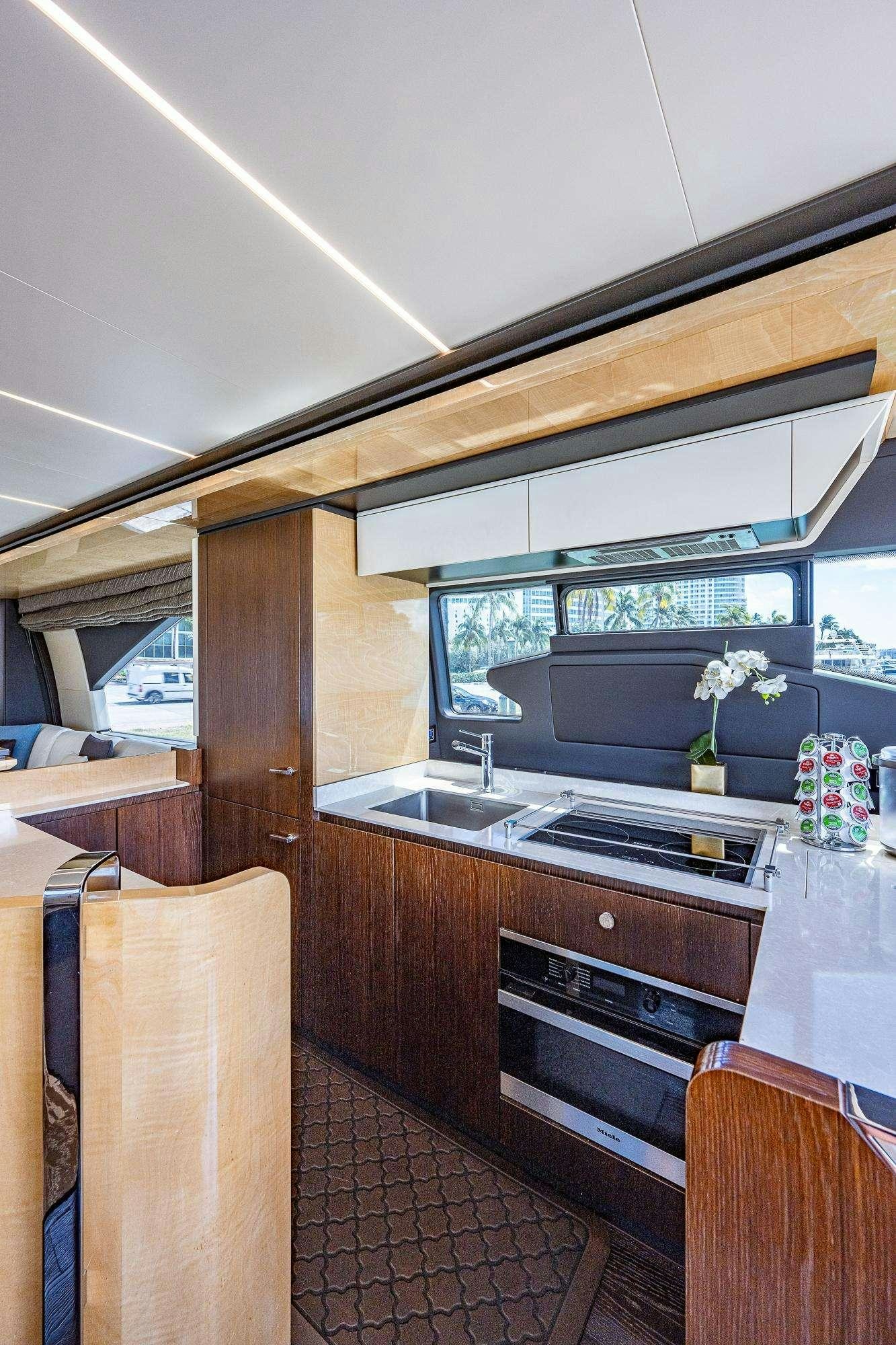 a kitchen with a large window aboard STAYSEA Yacht for Charter