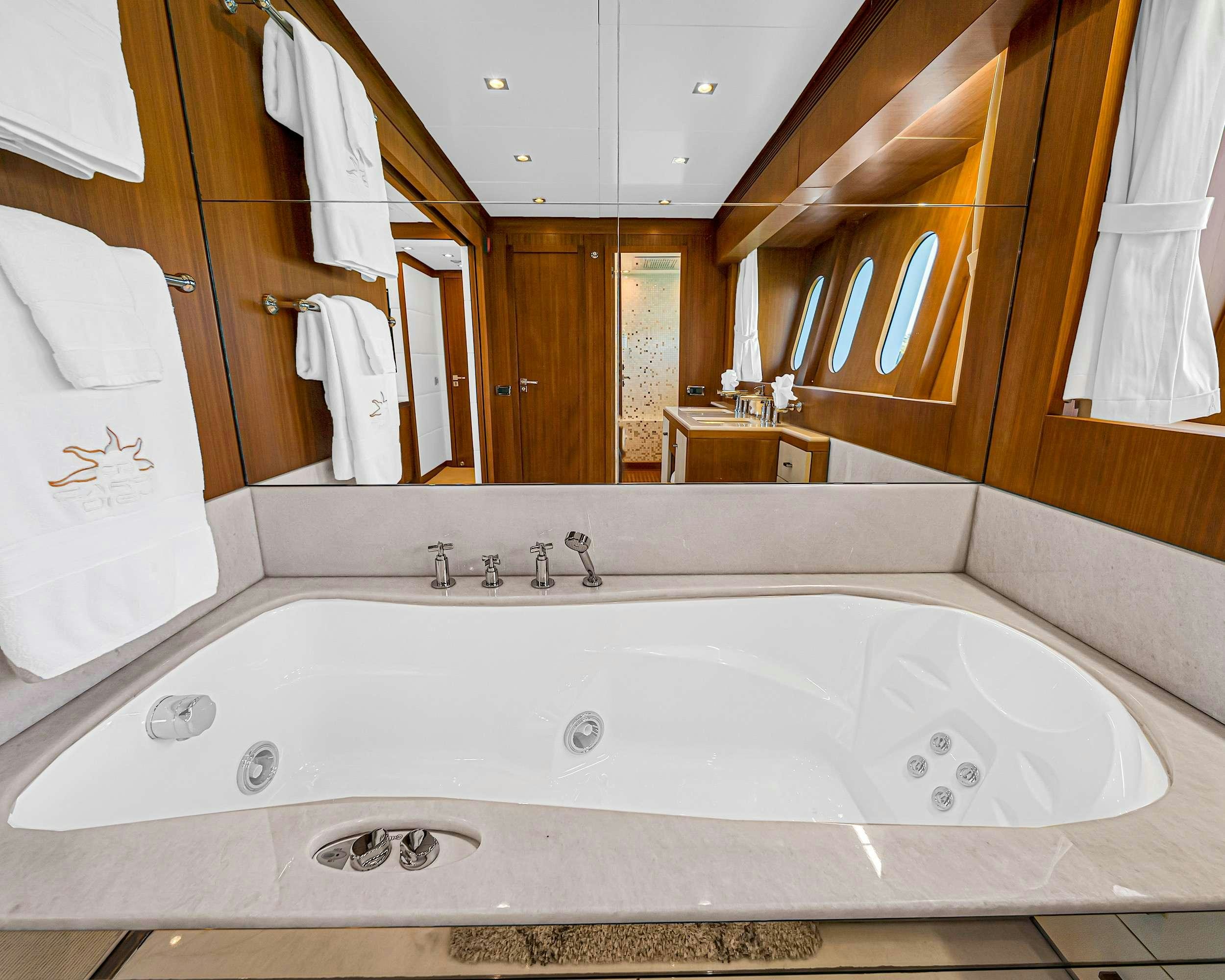 a large white bathtub in a bathroom aboard CARPE DIEM Yacht for Charter