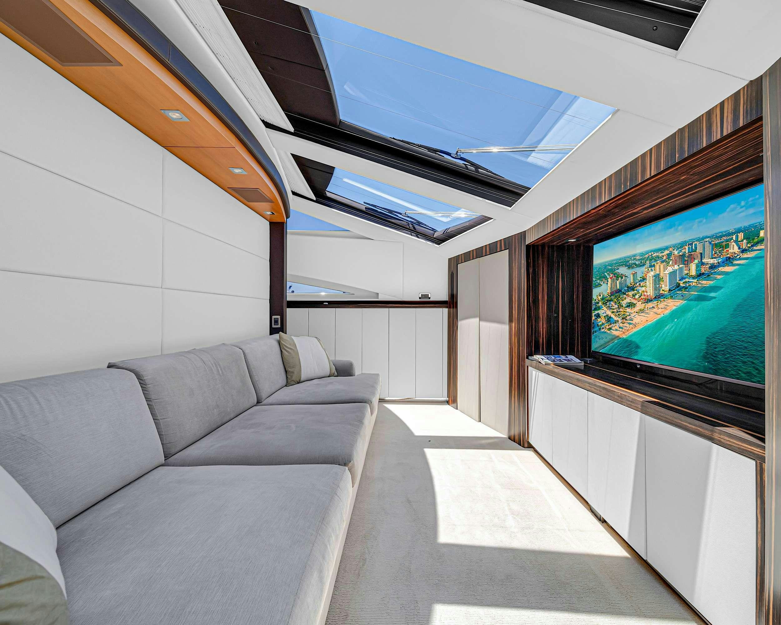 a room with a couch and a tv aboard CARPE DIEM Yacht for Charter