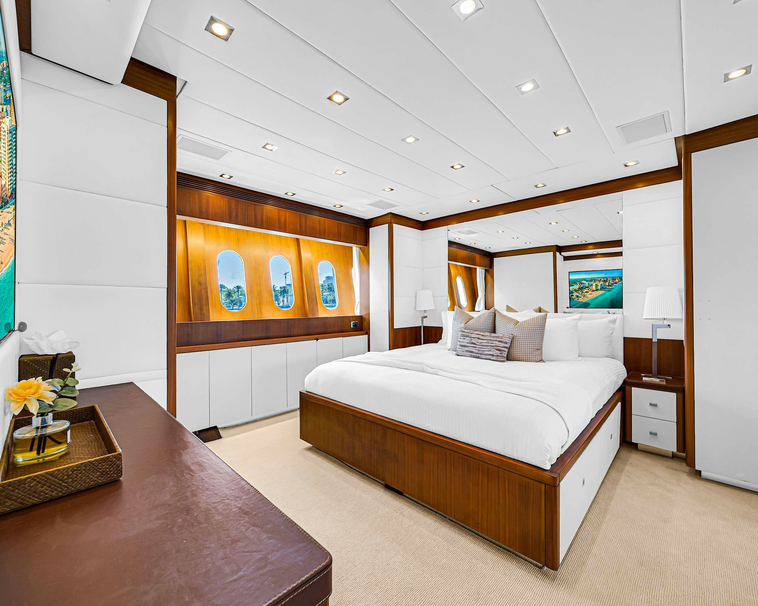 a bedroom with a bed and a desk aboard CARPE DIEM Yacht for Charter