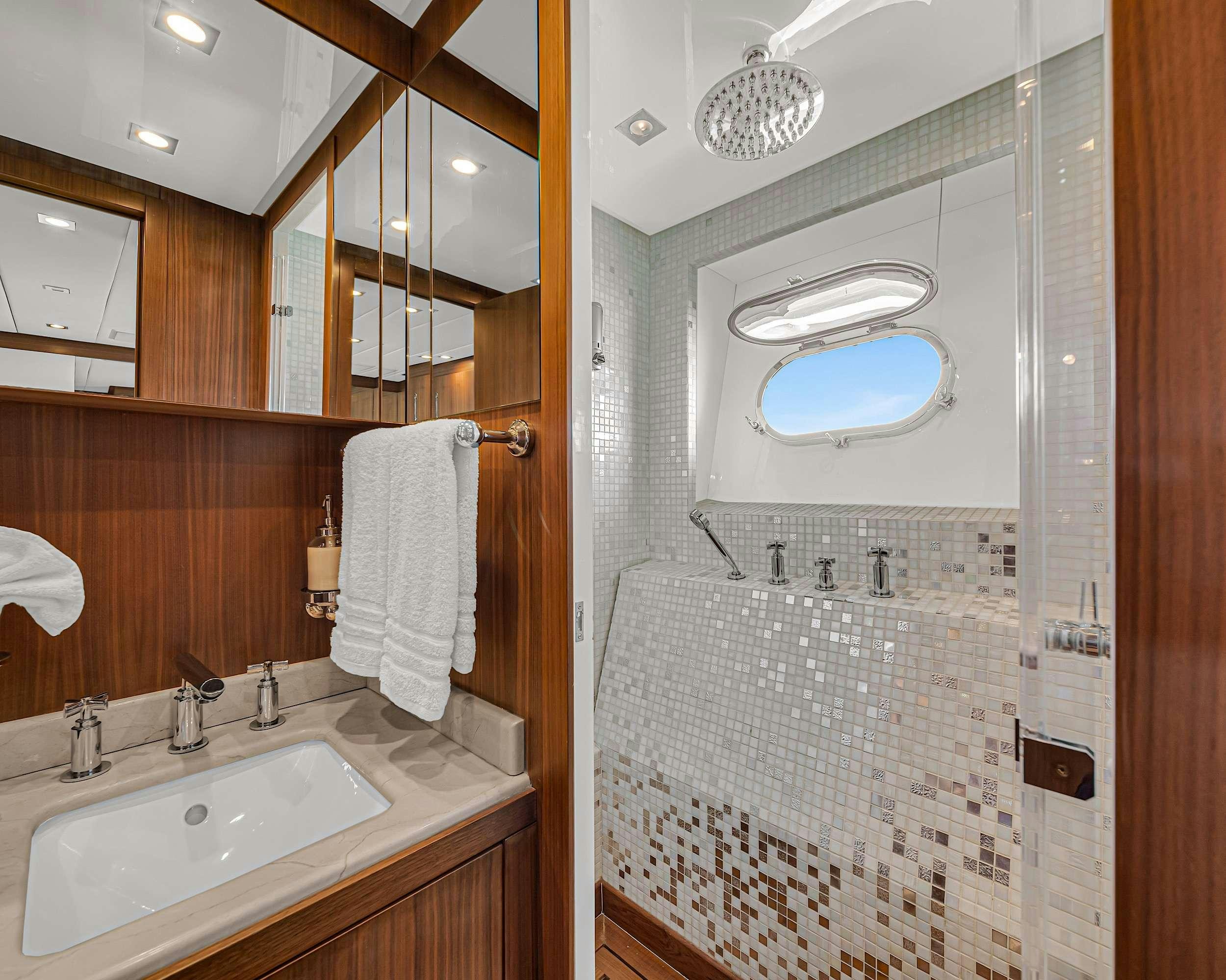 a bathroom with a sink and a mirror aboard CARPE DIEM Yacht for Charter