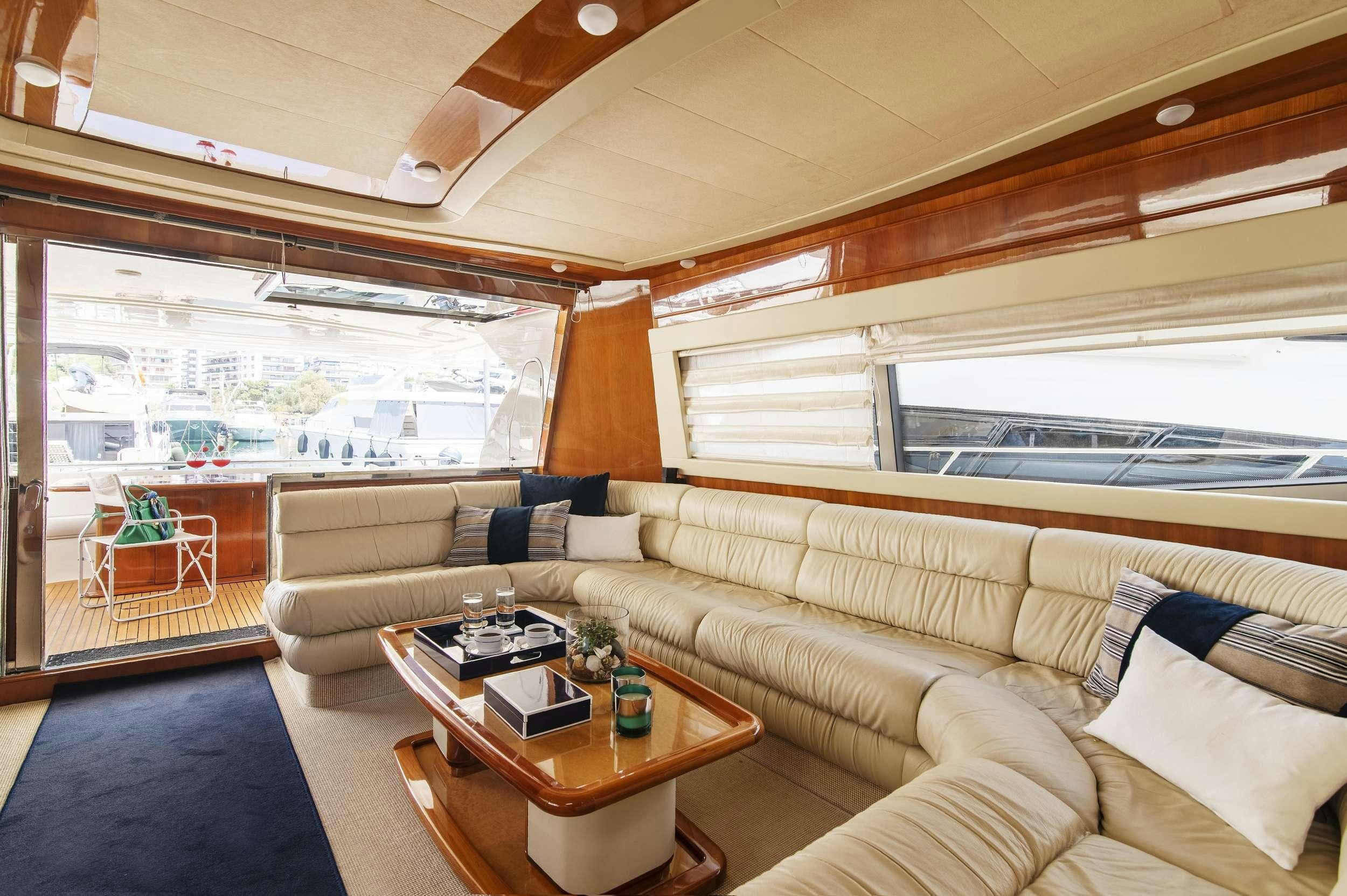 a living room with a couch and a table aboard VENTUS 21 Yacht for Charter