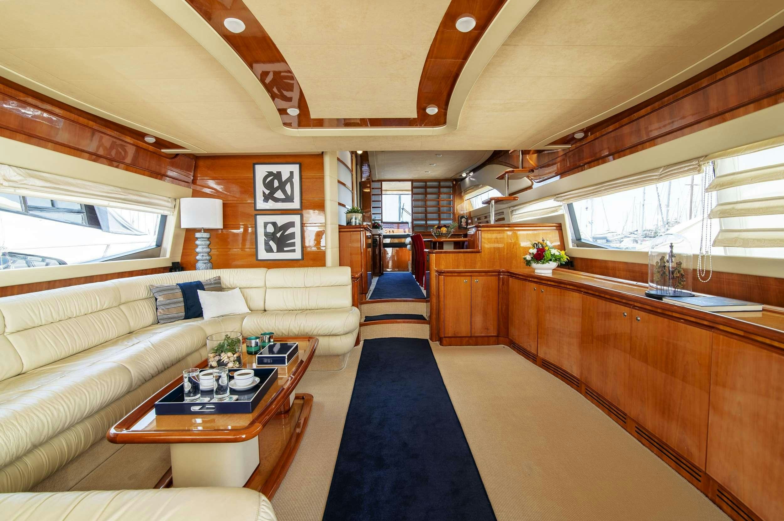 a living room with a couch and a table aboard VENTUS 21 Yacht for Charter