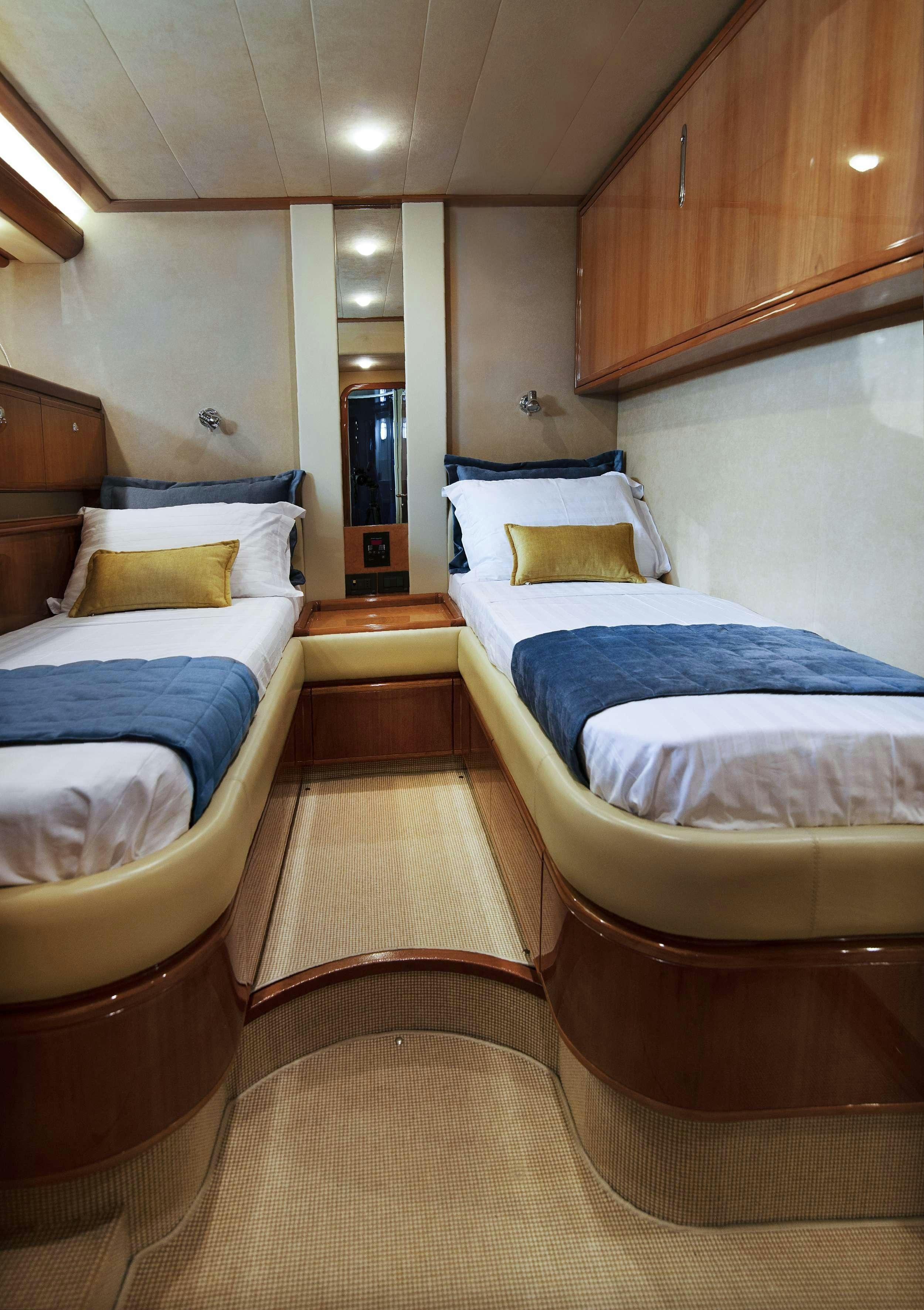 a room with several beds aboard VENTUS 21 Yacht for Charter