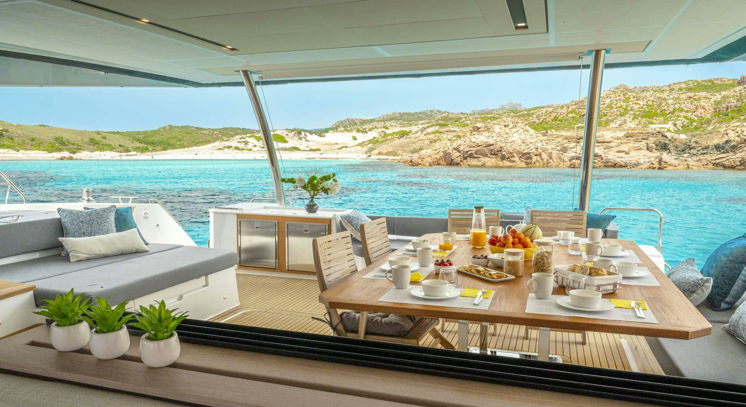 a table with food on it by a pool aboard SEMPER FIDELIS Yacht for Charter