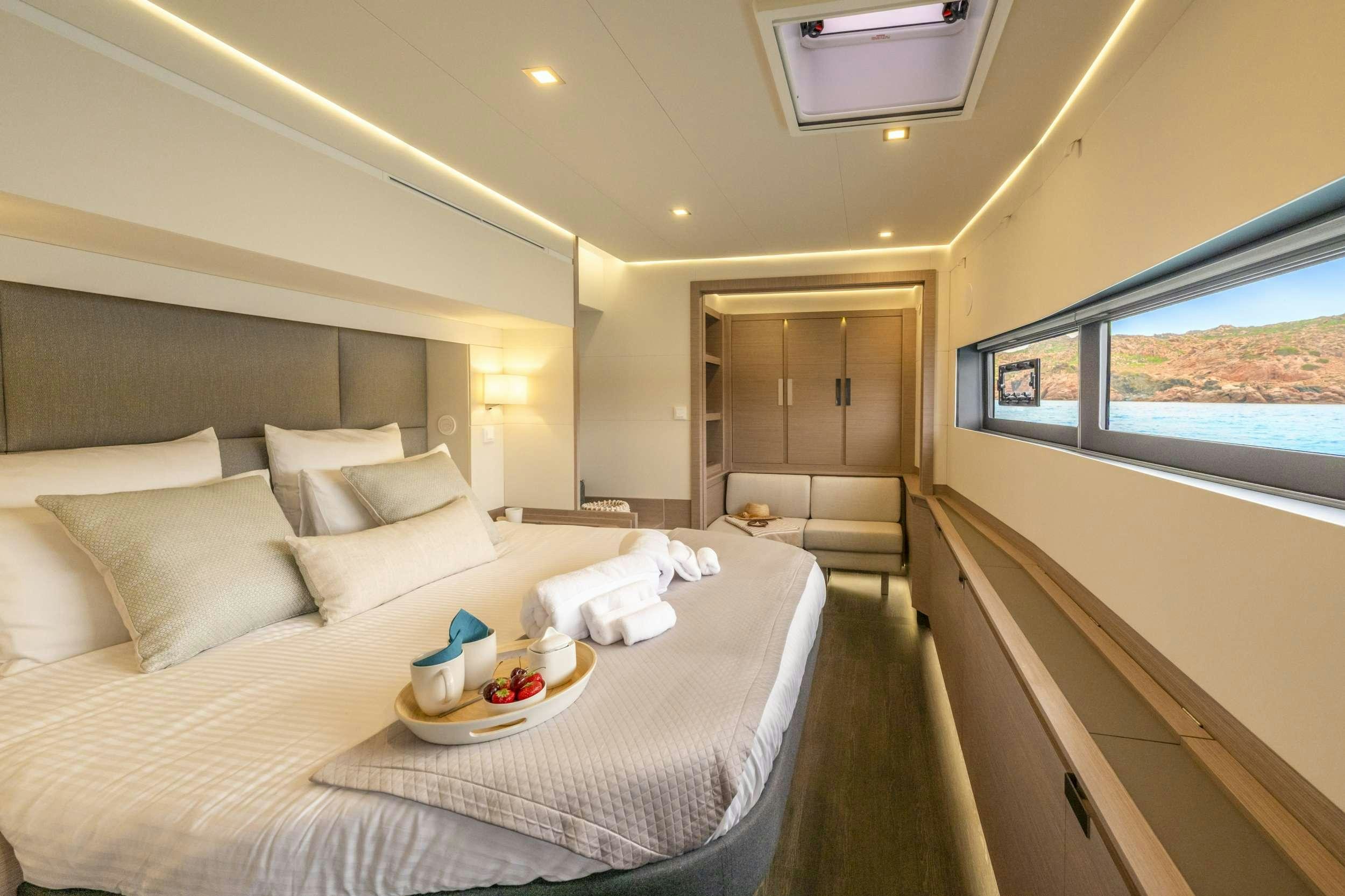 a bed with a white sheet and pillows on it aboard SEMPER FIDELIS Yacht for Charter