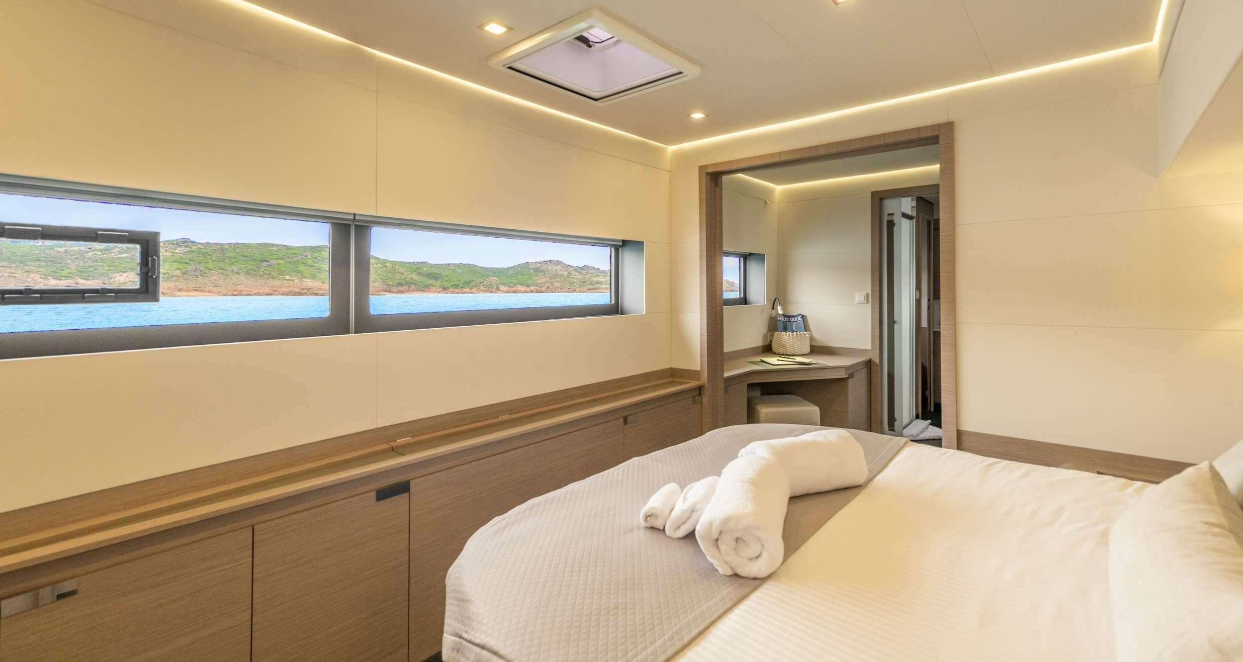 a room with a bed and a desk aboard SEMPER FIDELIS Yacht for Charter