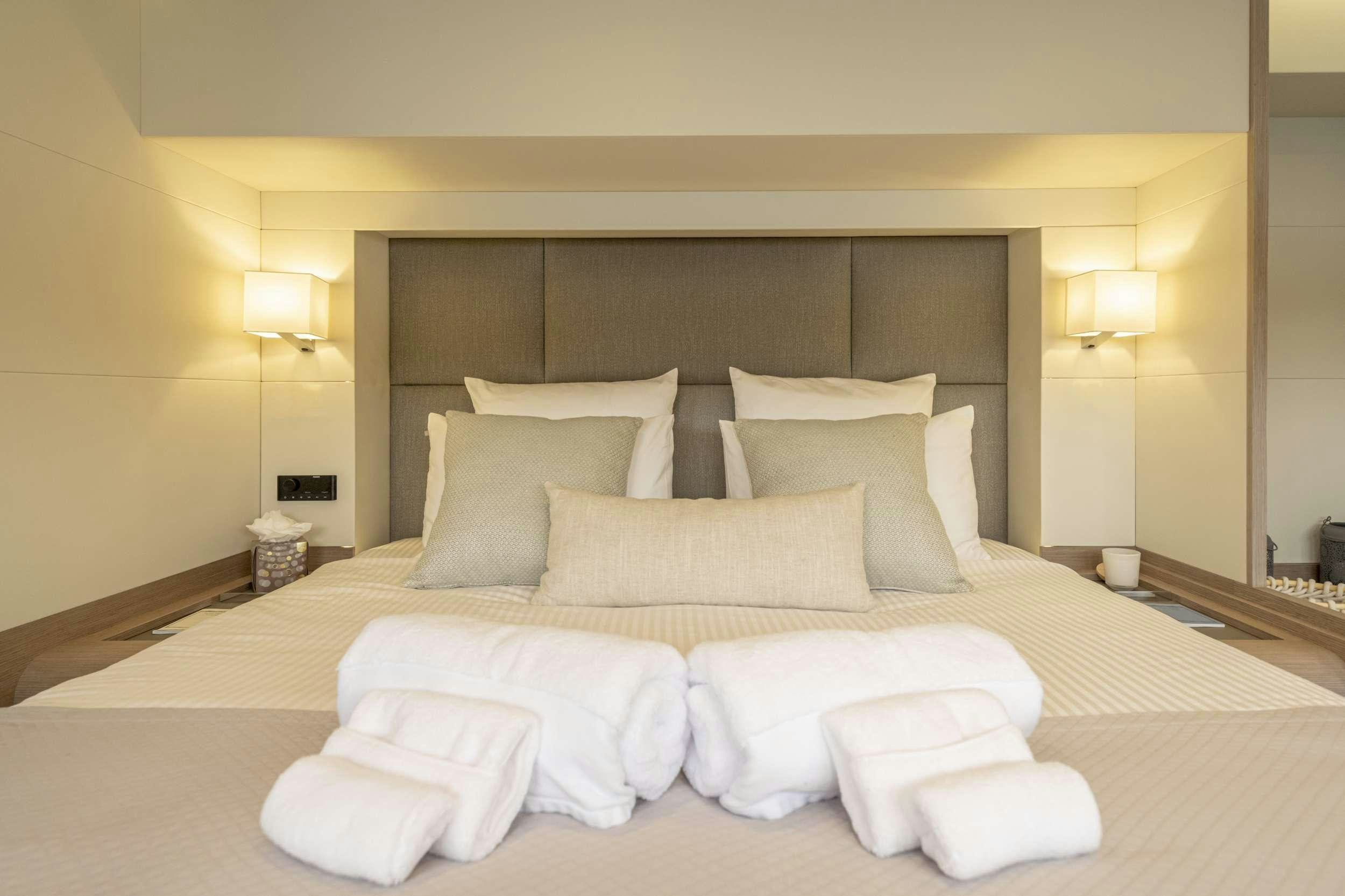 a bed with white pillows aboard SEMPER FIDELIS Yacht for Charter