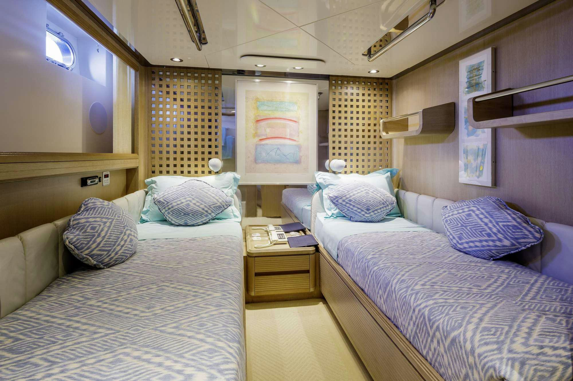 a couple of beds in a hotel room aboard NOMMO Yacht for Charter