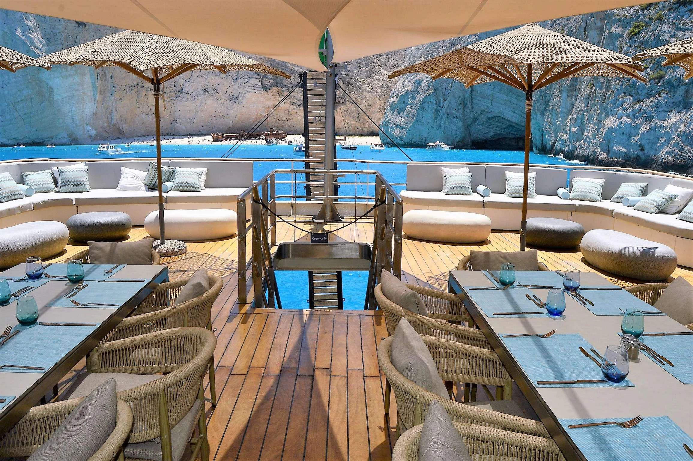 a deck with chairs and umbrellas aboard ELYSIUM Yacht for Charter