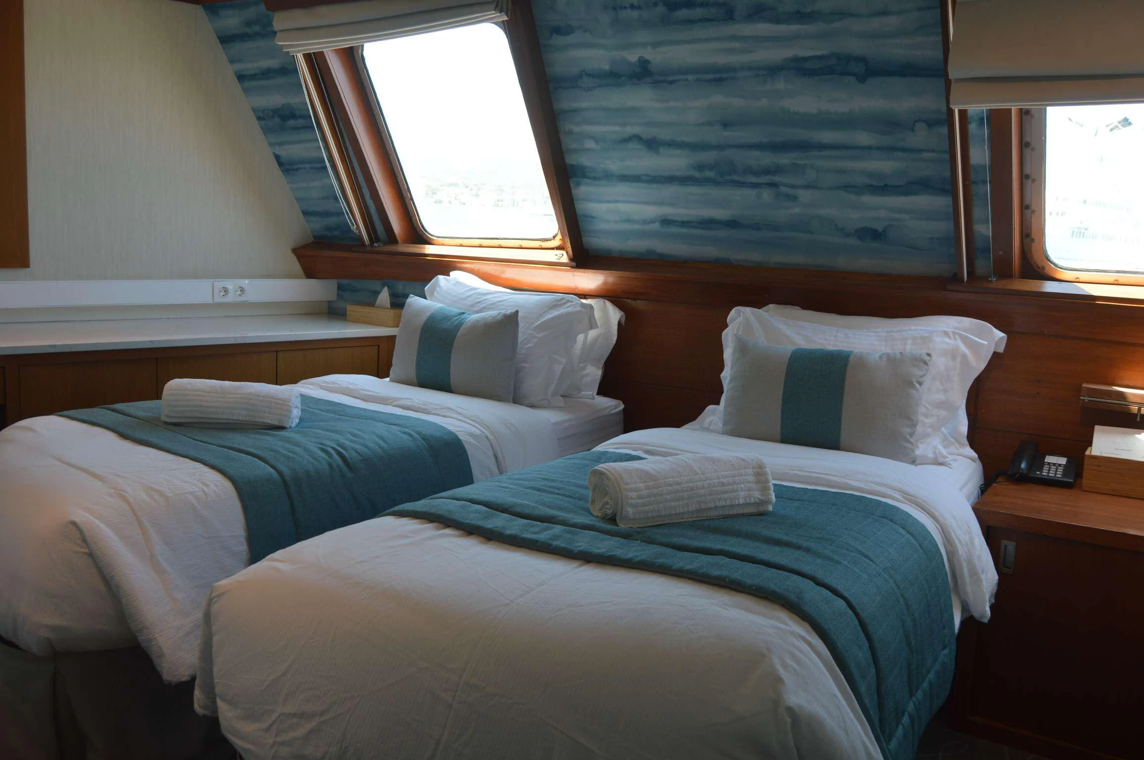 a couple of beds in a room aboard ELYSIUM Yacht for Charter