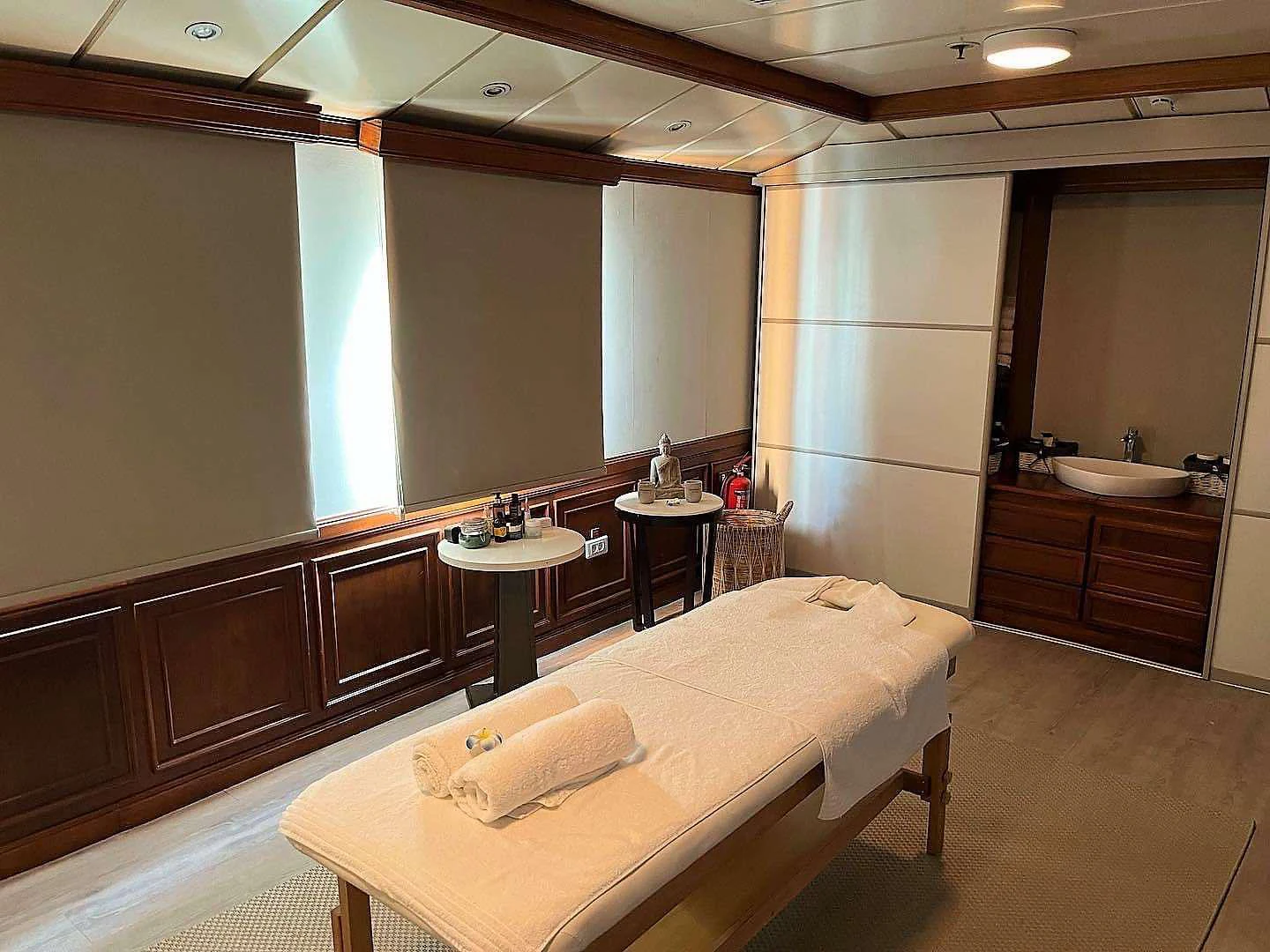 a hotel room with a bed and a table aboard ELYSIUM Yacht for Charter