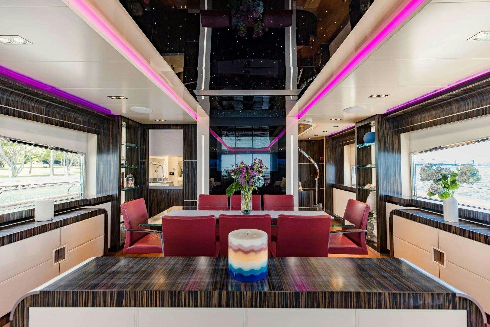 a room with tables and chairs aboard 95 DOMINATOR Yacht for Charter
