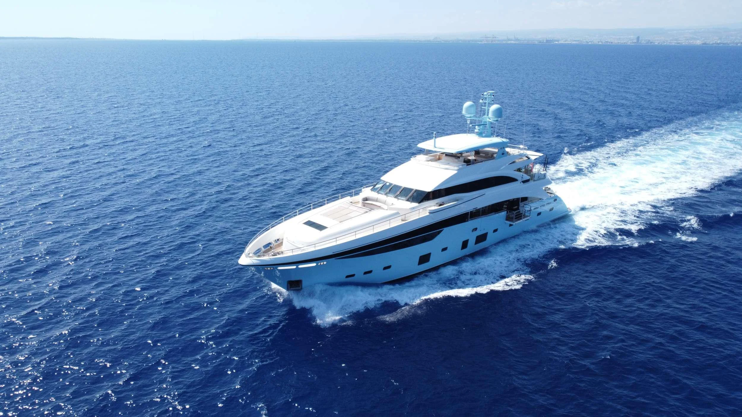 A sleek and modern yacht cruises through the open sea, showcasing its elegant design and powerful performance. aboard LE VERSEAU Yacht for Charter