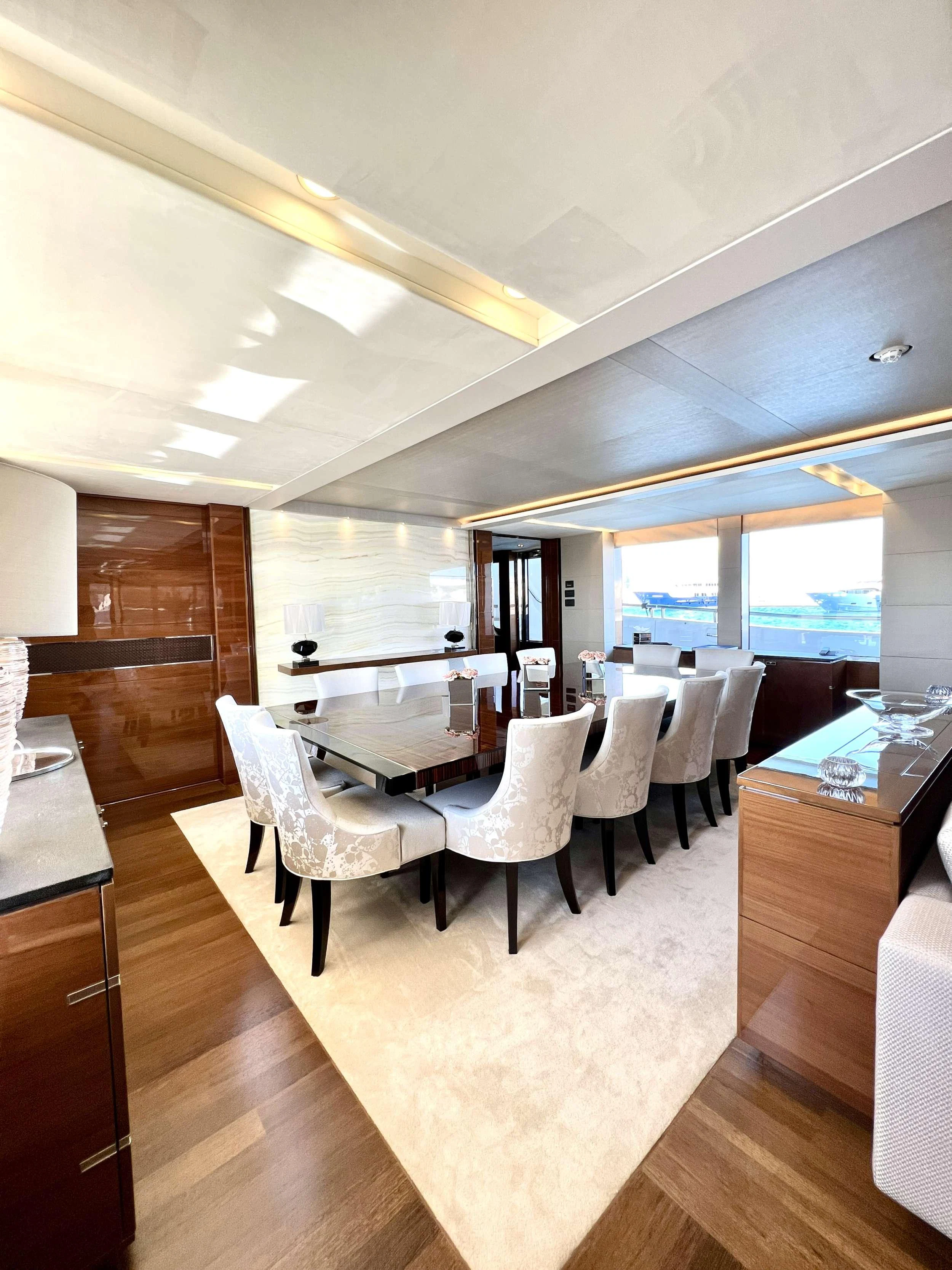 The yacht's dining area features elegant furnishings and ample natural light. aboard LE VERSEAU Yacht for Charter