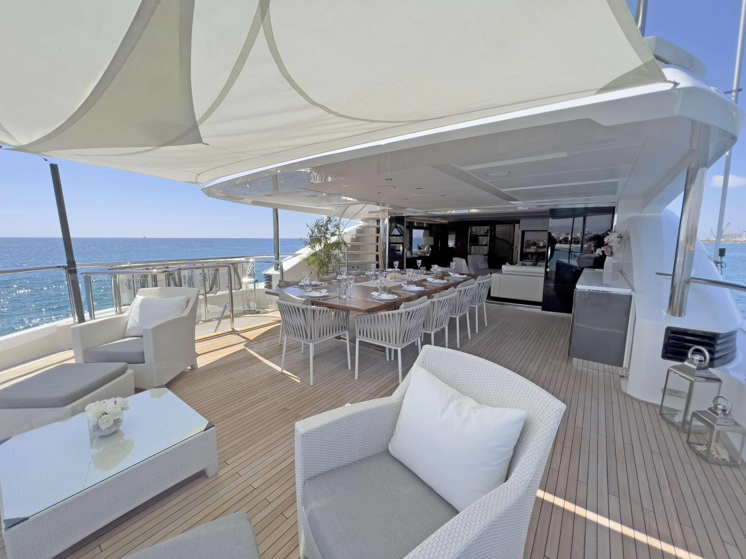 The aft deck offers an elegant outdoor dining area with comfortable seating and ocean views. aboard LE VERSEAU Yacht for Charter