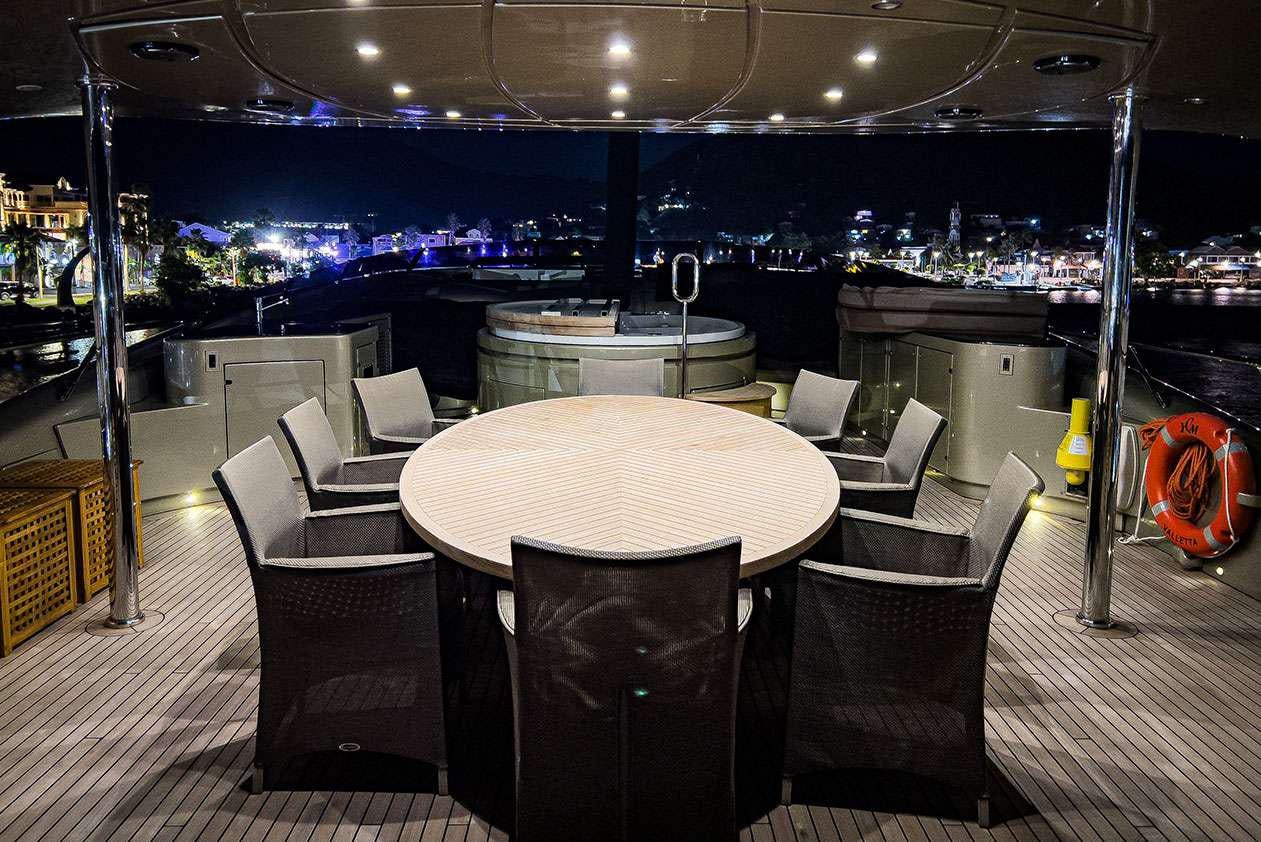 a table and chairs in a room aboard YCM 120 Yacht for Charter