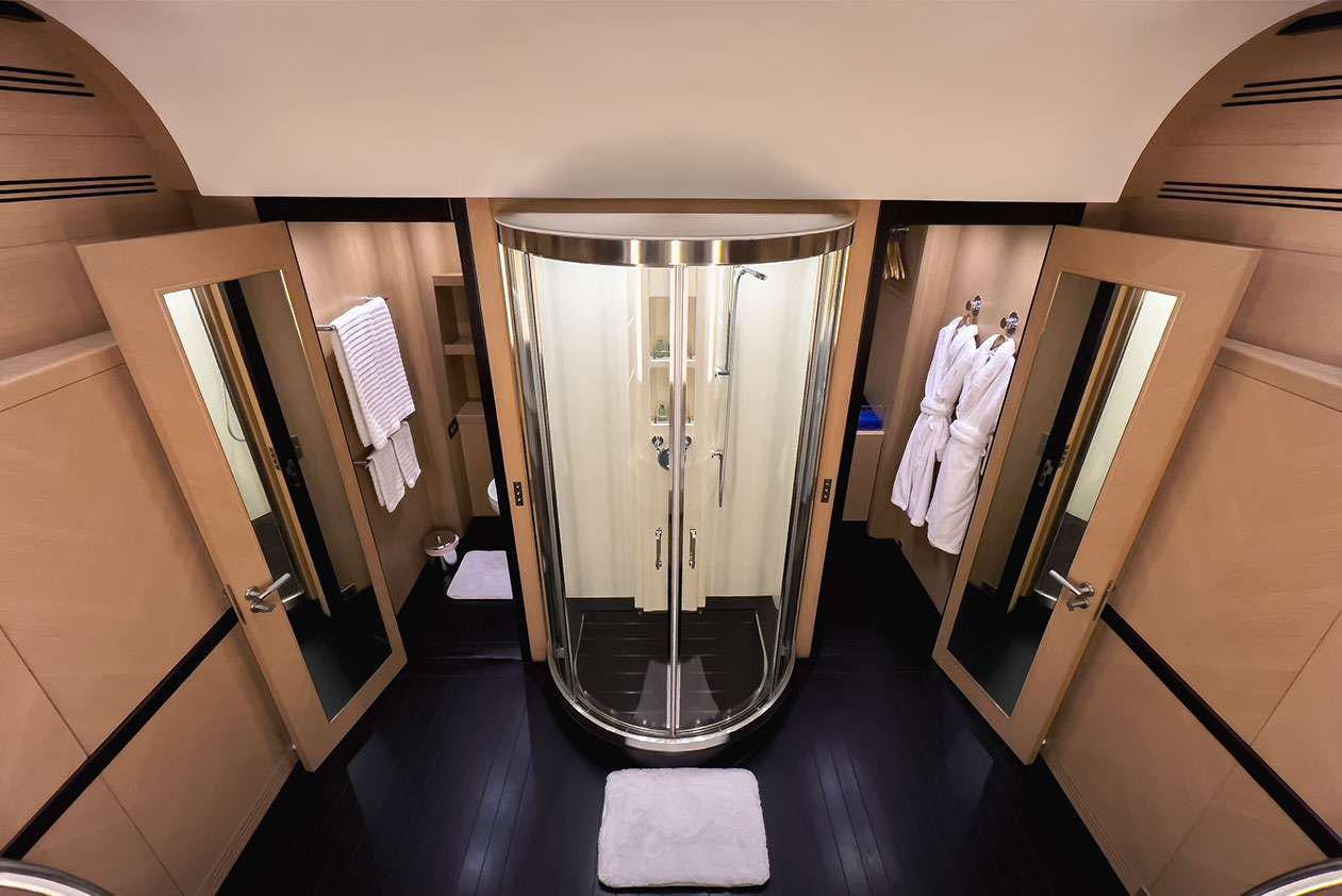 a bathroom with a large mirror aboard YCM 120 Yacht for Charter