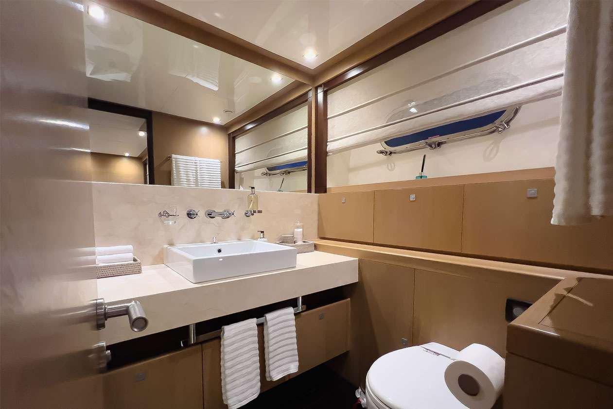 a bathroom with a sink and toilet aboard YCM 120 Yacht for Charter