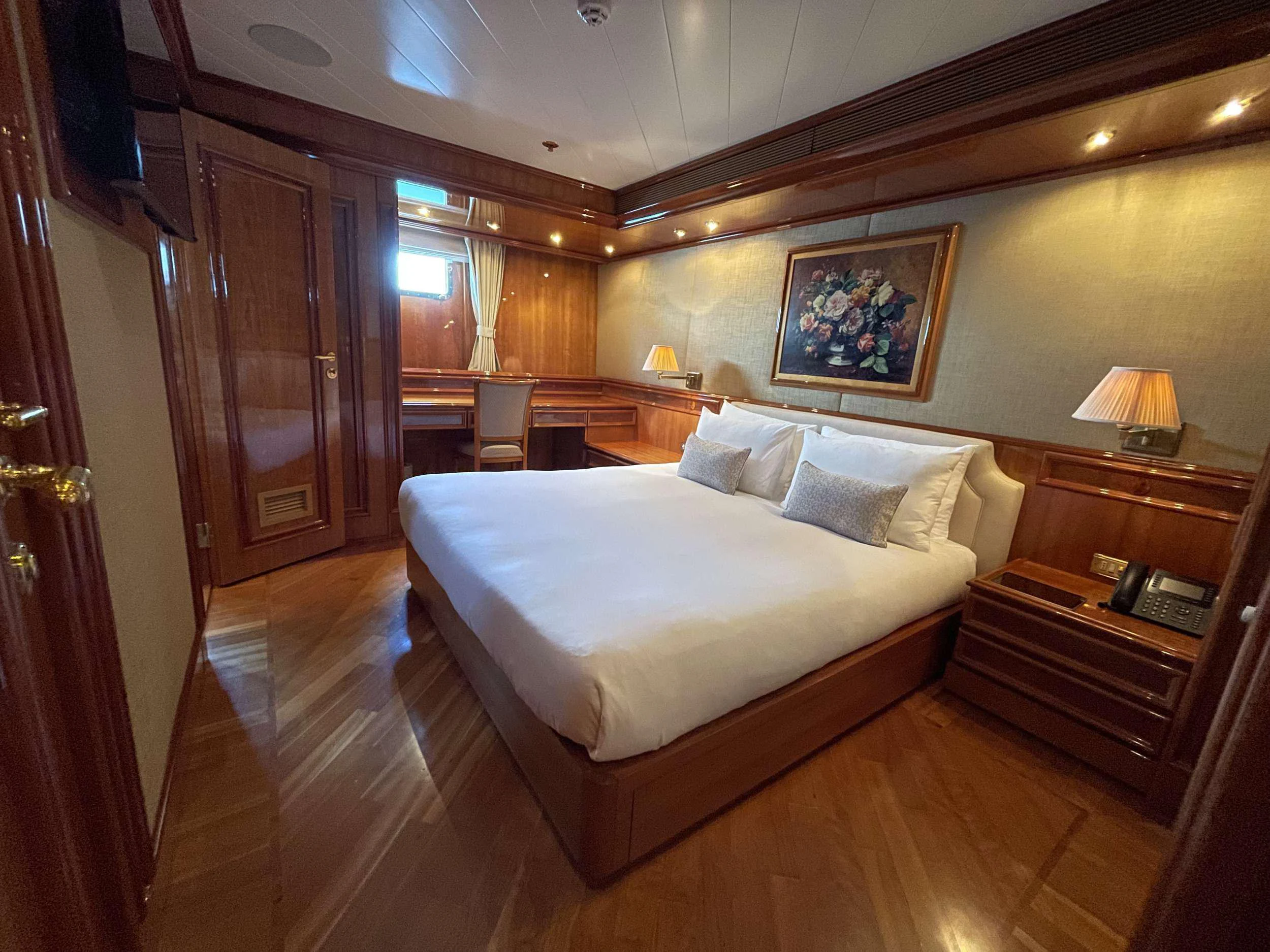 a bedroom with a bed and a desk aboard ISABELL PRINCESS OF THE SEA Yacht for Charter