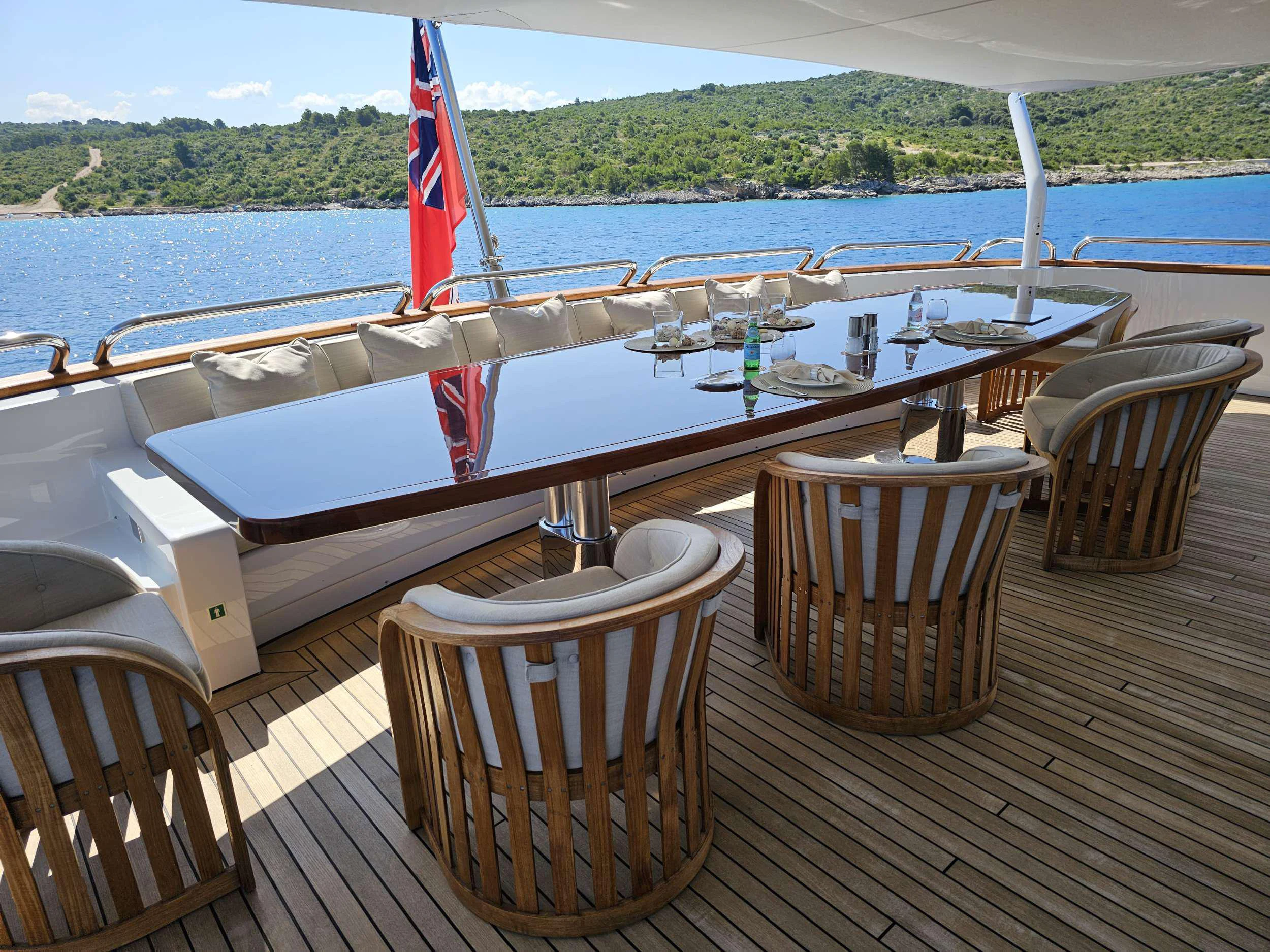 a wooden table on a deck overlooking a body of water aboard ISABELL PRINCESS OF THE SEA Yacht for Charter