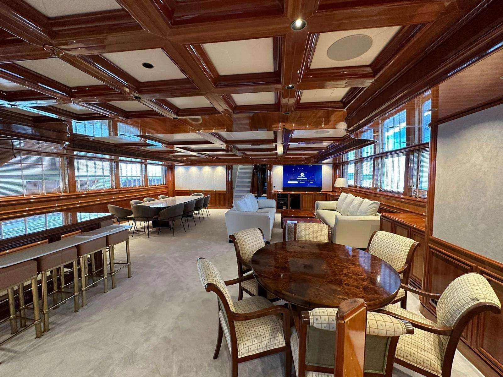 a room with tables and chairs aboard ISABELL PRINCESS OF THE SEA Yacht for Charter