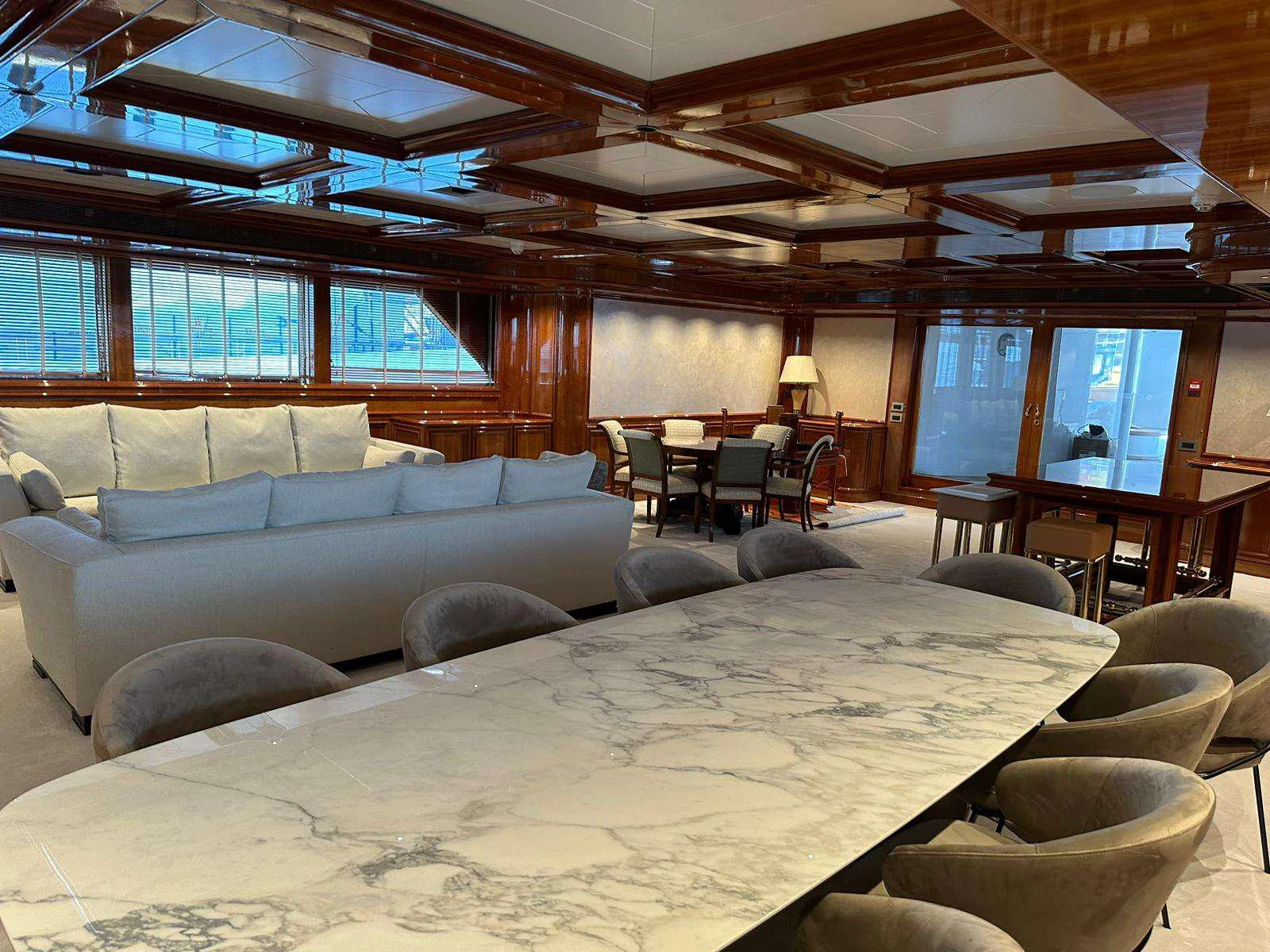 a large living room with a large table and chairs aboard ISABELL PRINCESS OF THE SEA Yacht for Charter