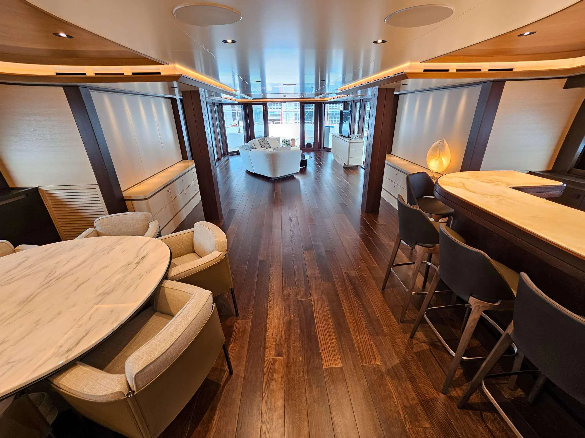 a room with a wood floor and tables and chairs aboard ISABELL PRINCESS OF THE SEA Yacht for Charter