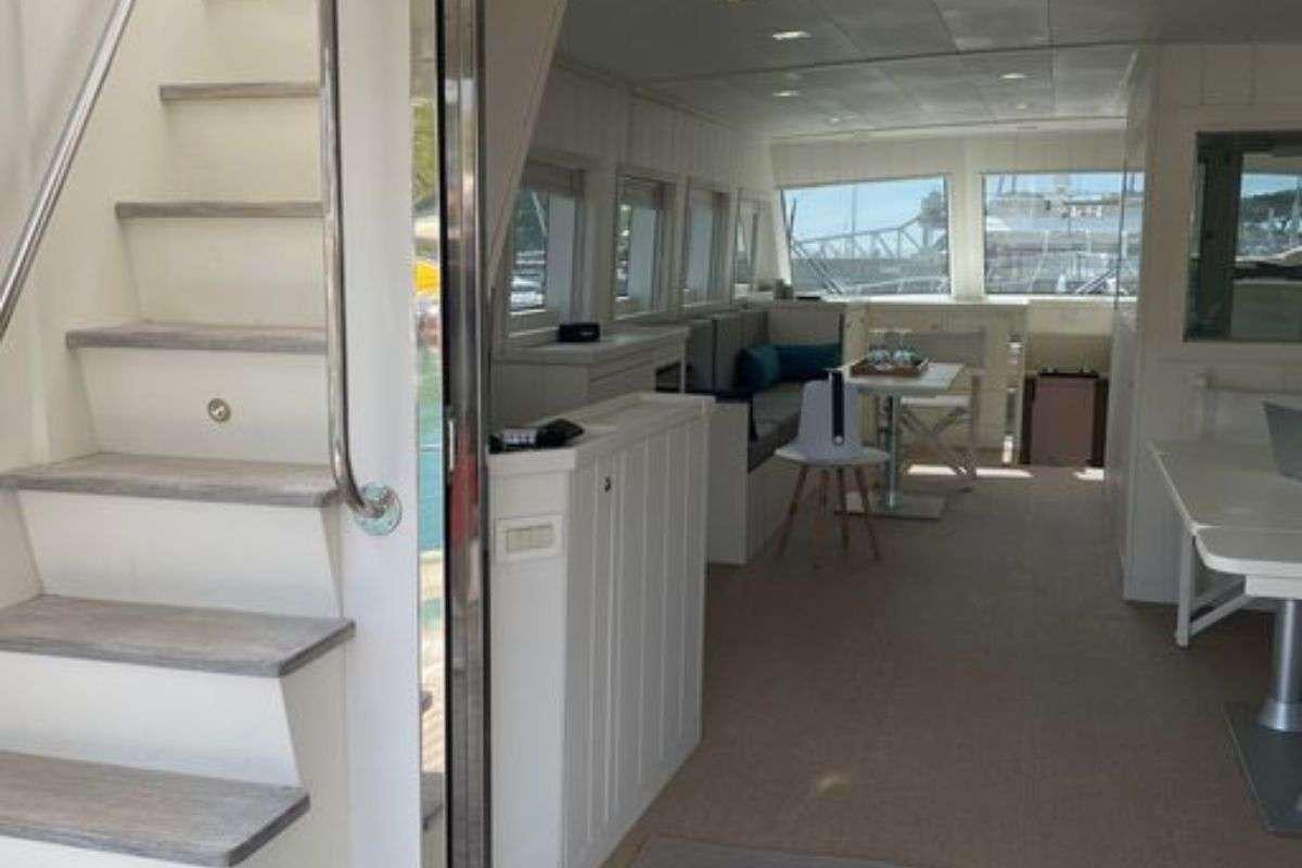 a room with a desk and chairs aboard FLAMENGA Yacht for Charter